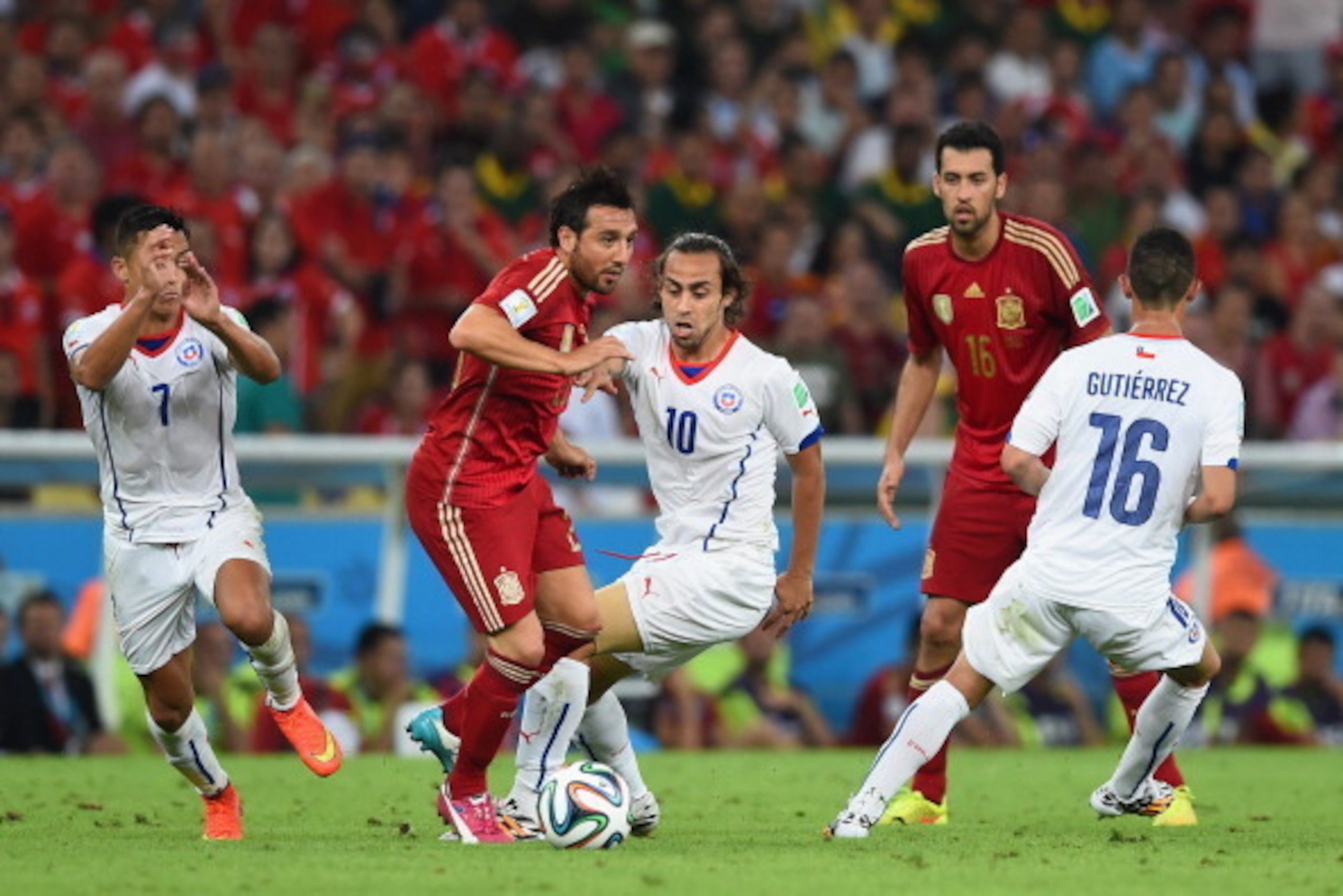 RIO DE JANEIRO, BRAZIL - JUNE 18:  Santi Cazorla of Spain and Jorge Valdivia of Chile  compete for the ball during the 2014 FIFA World Cup Brazil Group B match between Spain and Chile at Maracana on June 18, 2014 in Rio de Janeiro, Brazil.  (Photo by Matt