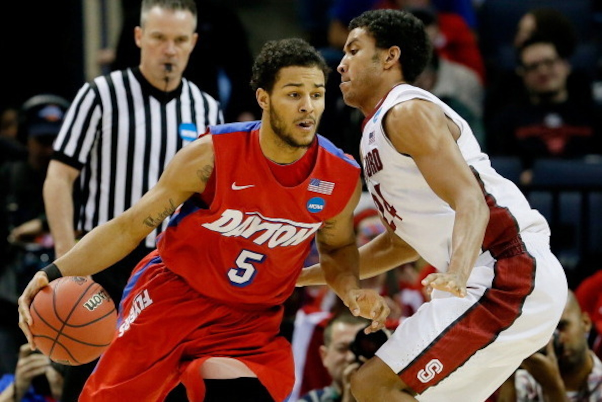 MEMPHIS, TN - MARCH 27: Devin Oliver #5 of the Dayton Flyers drives to the basket as Josh Huestis #24 of the Stanford Cardinal defends during a regional semifinal of the 2014 NCAA Men's Basketball Tournament at the FedExForum on March 27, 2014 in Memphis, MEMPHIS, TN - MARCH 27: Devin Oliver #5 of the Dayton Flyers drives to the basket as Josh Huestis #24 of the Stanford Cardinal defends during a regional semifinal of the 2014 NCAA Men's Basketball Tournament at the FedExForum on March 27, 2014 in Memphis,