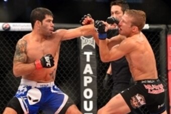 Oct 9, 2013; Barueri, Sao Paulo, Brazil; Raphael Assuncao  (blue shorts) fights against  TJ Dillashaw (black shorts) during UFC Fight Night 29 at Jose Correa Arena. Mandatory Credit: Jason Silva-USA TODAY Sports