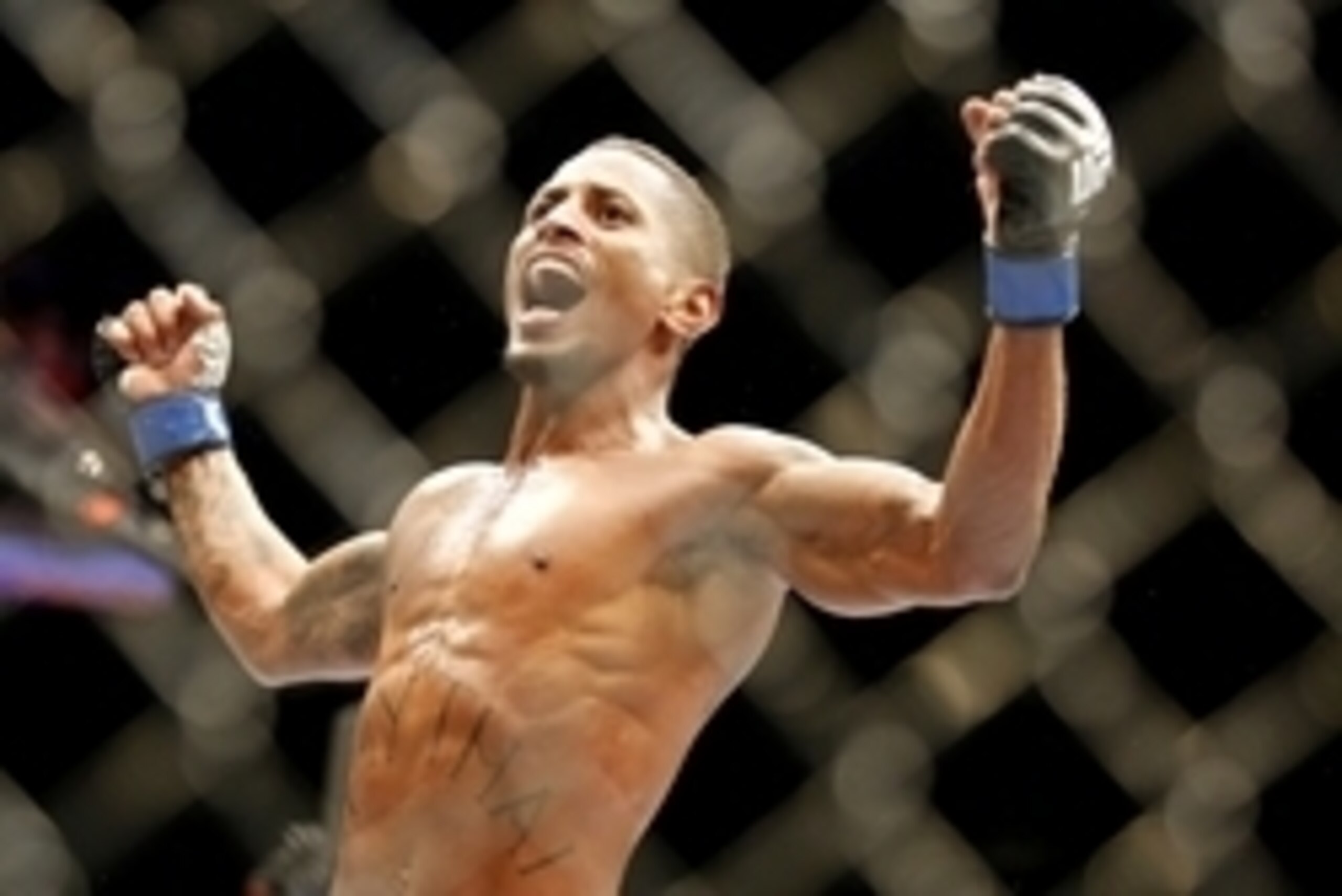 May 10, 2014; Cincinnati, OH, USA; Johnny Eduardo (blue gloves) celebrates after knocking out Eddie Wineland (not pictured) in the first round of a preliminary bantamweight bout at US Bank Arena. Mandatory Credit: Joe Maiorana-USA TODAY Sports