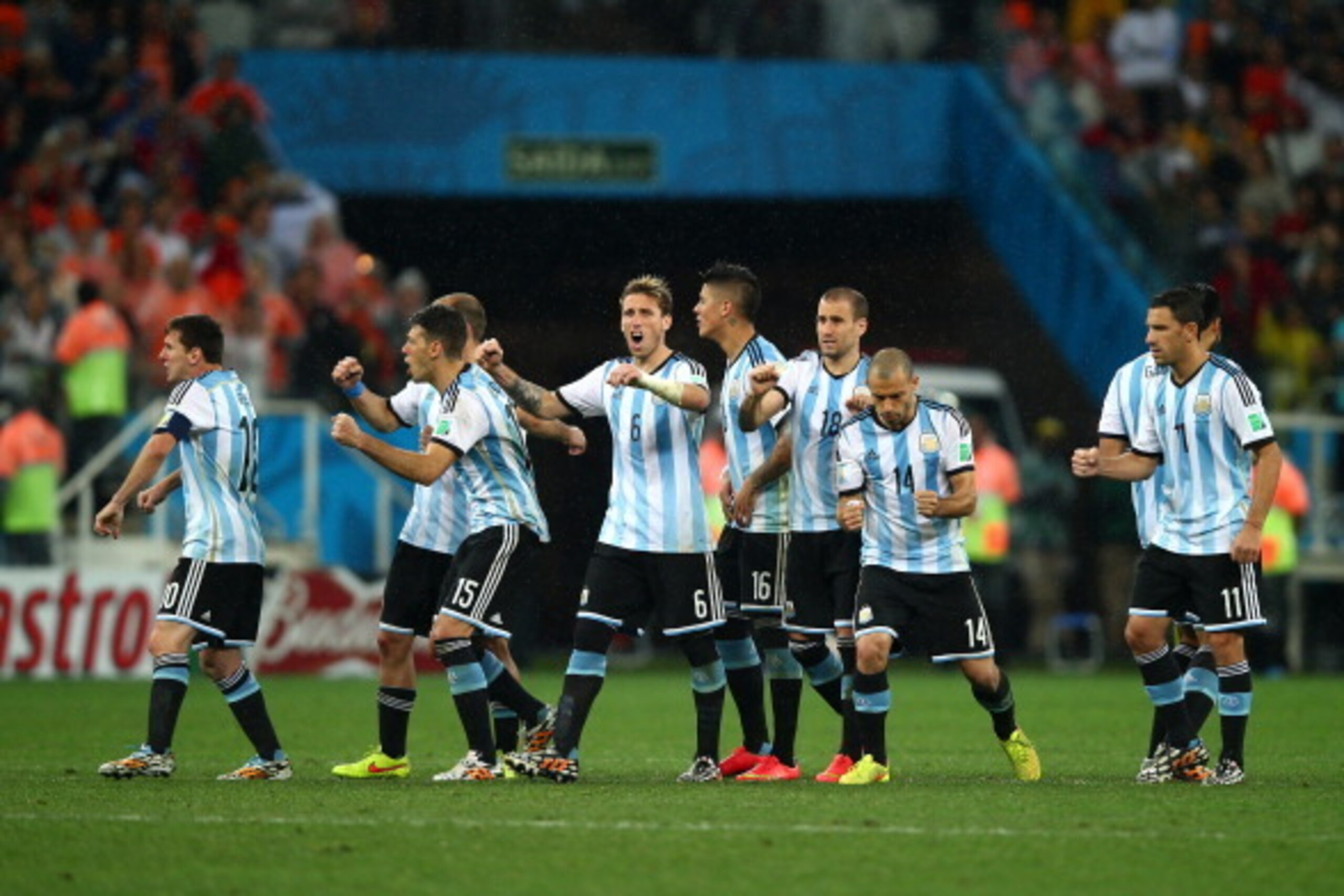 SAO PAULO, BRAZIL - JULY 09: (L-R) Lionel Messi, Pablo Zabaleta, Martin Demichelis, Lucas Biglia, Marcos Rojo, Rodrigo Palacio, Javier Mascherano, Ezequiel Garay and Maxi Rodriguez of Argentina react after a made penalty kick by teammate Sergio Aguero (no