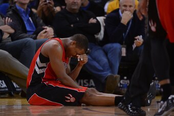 December 3, 2013; Oakland, CA, USA; Toronto Raptors point guard Kyle Lowry (7) reacts after an injury against the Golden State Warriors during the third quarter at Oracle Arena. The Warriors defeated the Raptors 112-103. Mandatory Credit: Kyle Terada-USA
