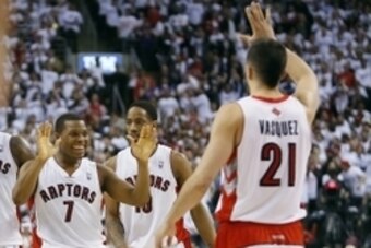 Apr 22, 2014; Toronto, Ontario, CAN;  Toronto Raptors guard Kyle Lowry (7) celebrates a late basket against the Brooklyn Nets with guard Greivis Vasquez (21) in game two during the first round of the 2014 NBA Playoffs at Air Canada Centre. Toronto defeate