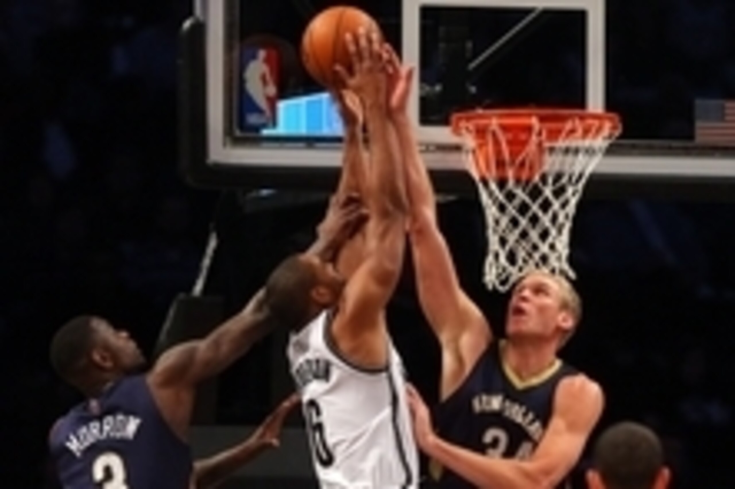 Feb 9, 2014; Brooklyn, NY, USA; Brooklyn Nets small forward Alan Anderson (6) shoots against New Orleans Pelicans shooting guard Anthony Morrow (3) and New Orleans Pelicans center Greg Stiemsma (34) during the fourth quarter of a game at Barclays Center. 