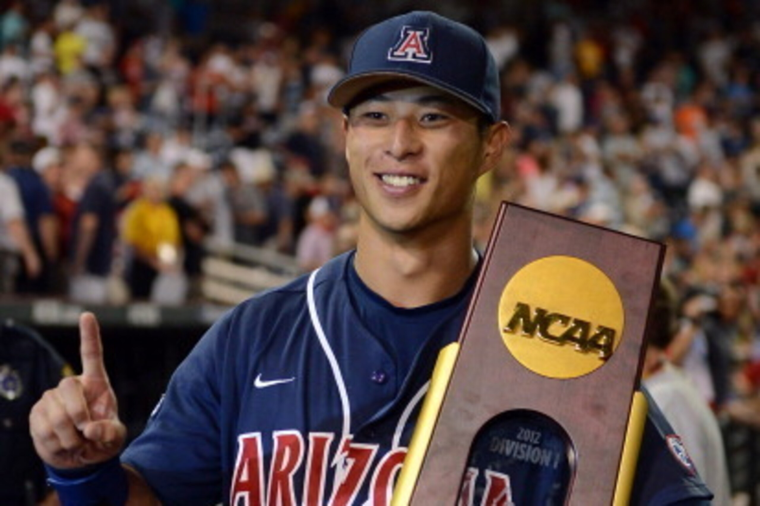 OMAHA, NE - JUNE 25:  Robert Refsnyder #2 of the Arizona Wildcats poses with the trophy after a 4-1 win and a 2-0 series sweep over the South Carolina Gamecocks after game 2 of the College World Series at TD Ameritrade Field on June 25, 2012 in Omaha, Neb