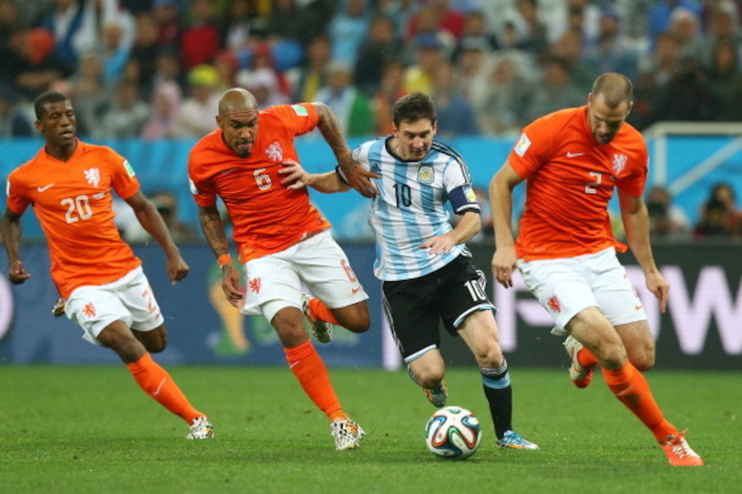 SAO PAULO, BRAZIL - JULY 09:  Lionel Messi of Argentina controls the ball as (L-R) Georginio Wijnaldum, Nigel de Jong and Ron Vlaar give chase during the 2014 FIFA World Cup Brazil Semi Final match between the Netherlands and Argentina at Arena de Sao Pau