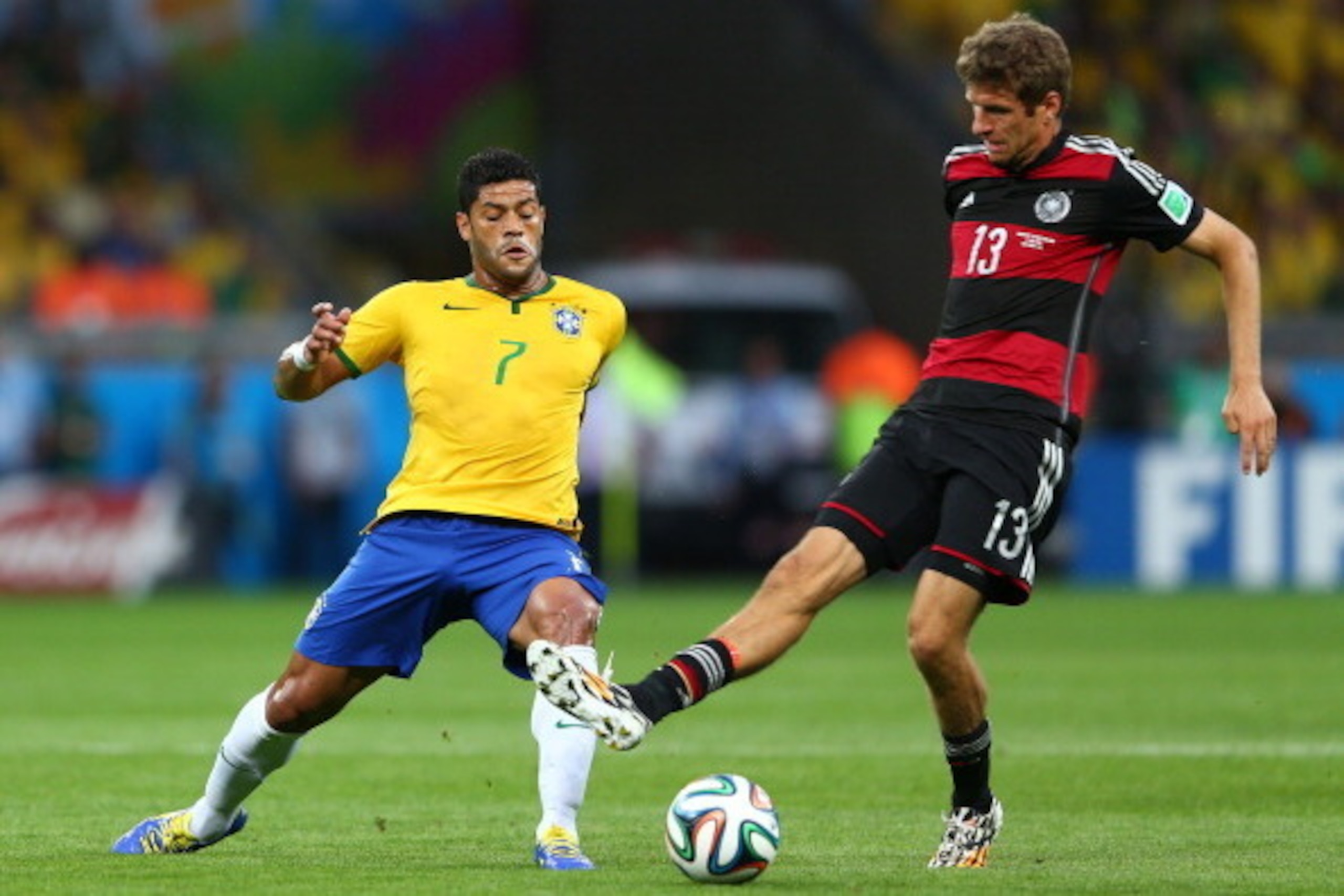 BELO HORIZONTE, BRAZIL - JULY 08:  Hulk of Brazil and Thomas Mueller of Germany compete for the ball during the 2014 FIFA World Cup Brazil Semi Final match between Brazil and Germany at Estadio Mineirao on July 8, 2014 in Belo Horizonte, Brazil.  (Photo b