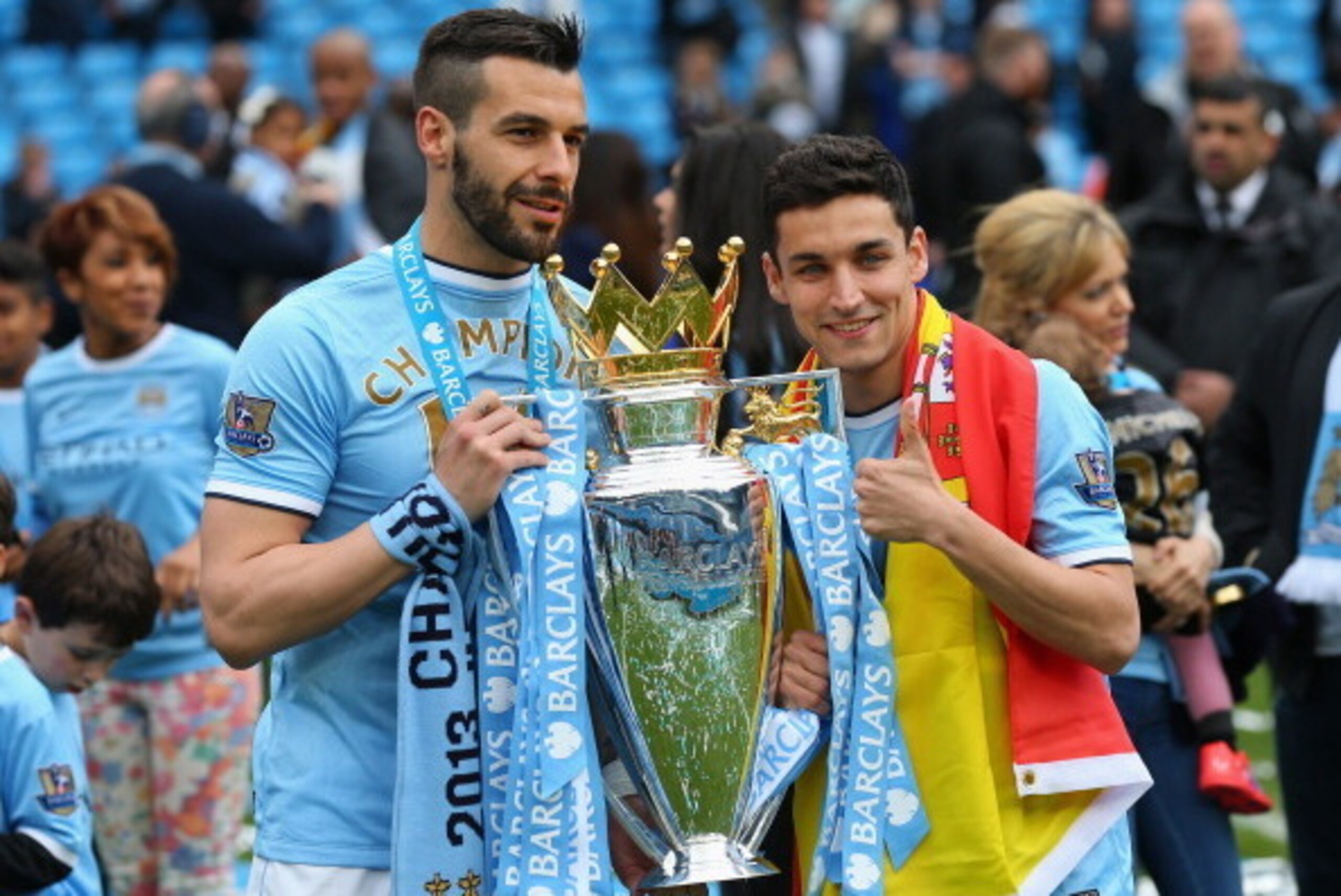 MANCHESTER, ENGLAND - MAY 11:  Alvaro Negredo of Manchester City and Jesus Navas (R) pose with the trophy at the end of the Barclays Premier League match between Manchester City and West Ham United at the Etihad Stadium on May 11, 2014 in Manchester, Engl