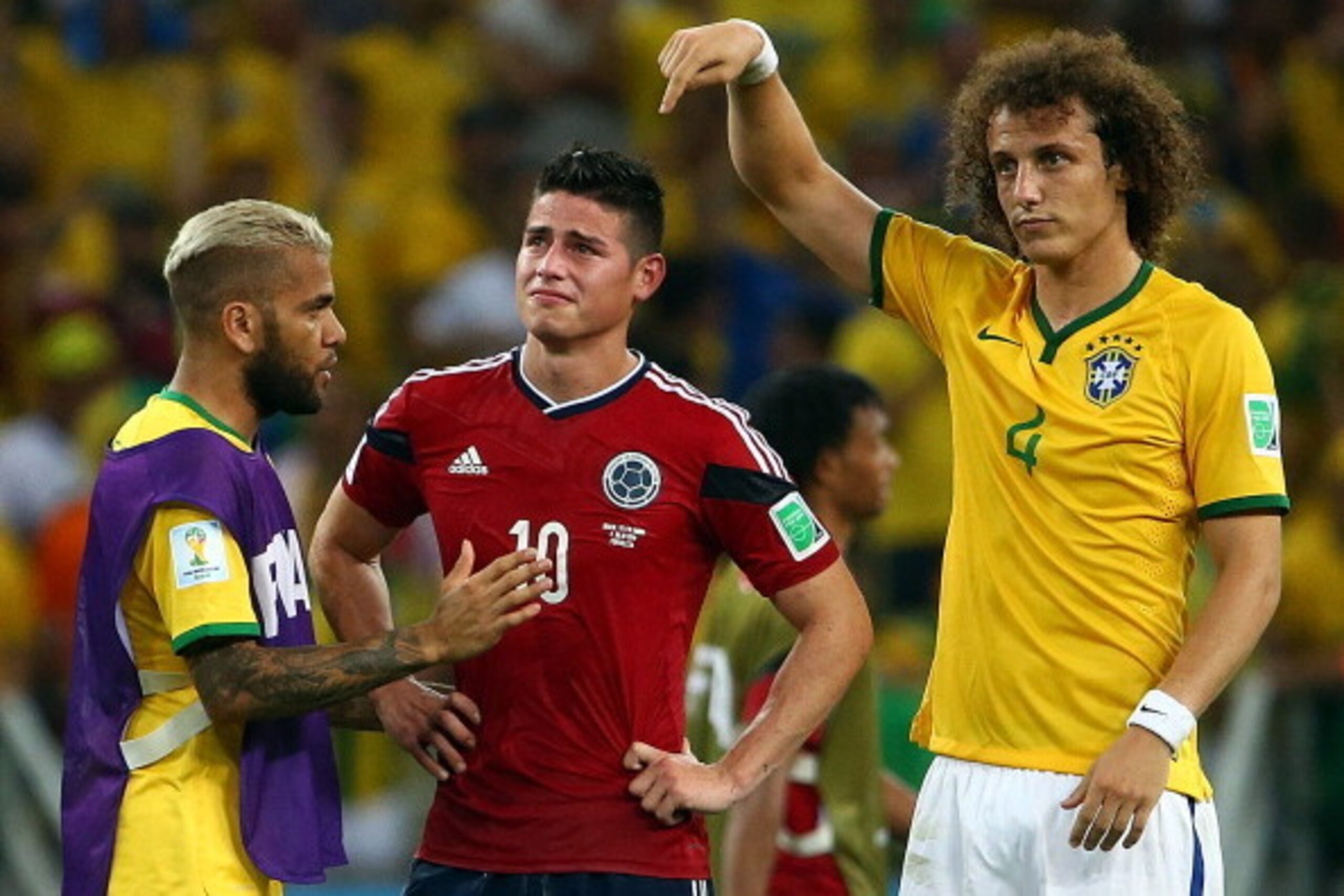 FORTALEZA, BRAZIL - JULY 04:  Dani Alves (L) and David Luiz of Brazil console James Rodriguez of Colombia after Brazil's 2-1 win during the 2014 FIFA World Cup Brazil Quarter Final match between Brazil and Colombia at Castelao on July 4, 2014 in Fortaleza