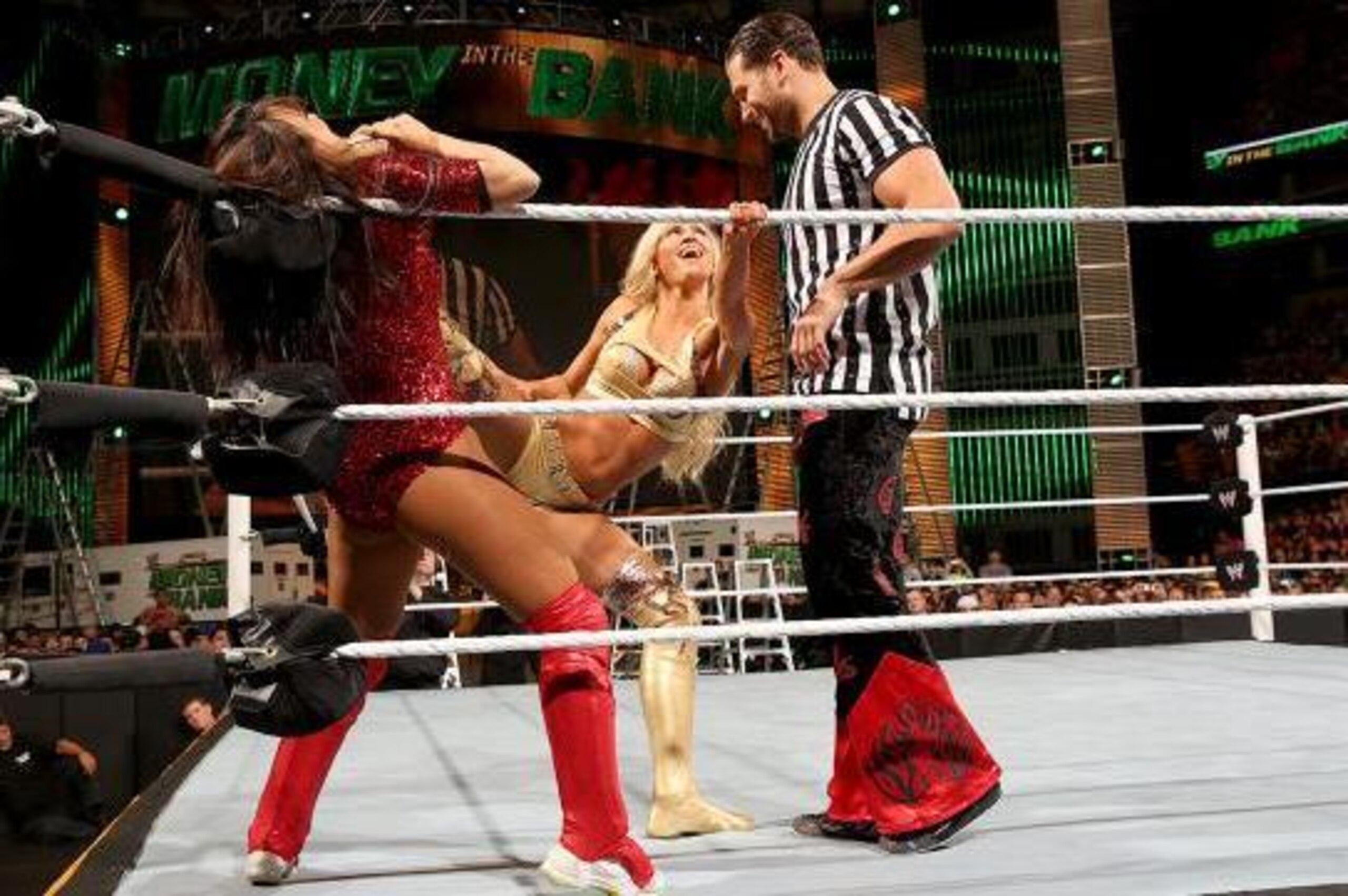 Summer Rae pins Layla in the corner with her long legs.