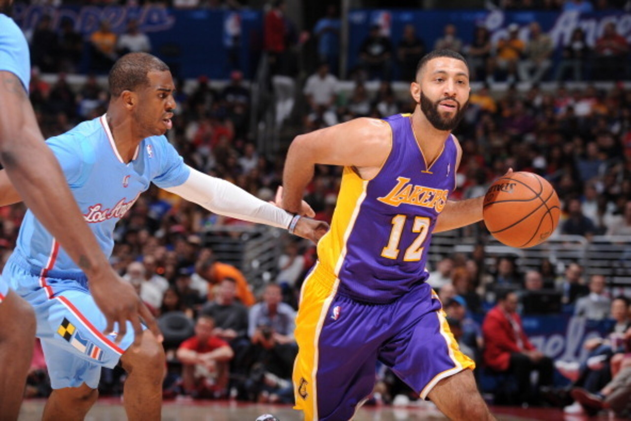 LOS ANGELES, CA - APRIL 6: Kendall Marshall #12 of the Los Angeles Lakers dribbles against Chris Paul #3 of the Los Angeles Clippers at Staples Center on April 6, 2014 in Los Angeles, California. NOTE TO USER: User expressly acknowledges and agrees that, 