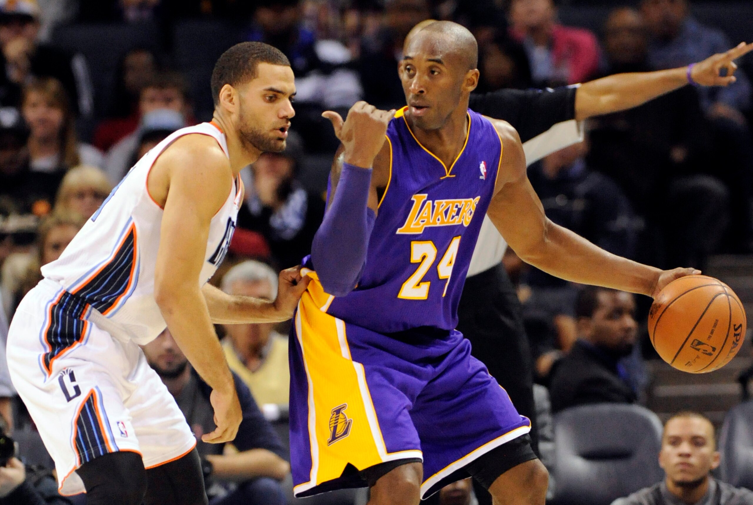 Dec 14, 2013; Charlotte, NC, USA; Los Angeles Lakers guard Kobe Bryant (24) looks to pass as he is defended by Charlotte Bobcats forward Jeffery Taylor (44) during the second half of the game at Time Warner Cable Arena. Lakers win 88-85. Mandatory Credit: