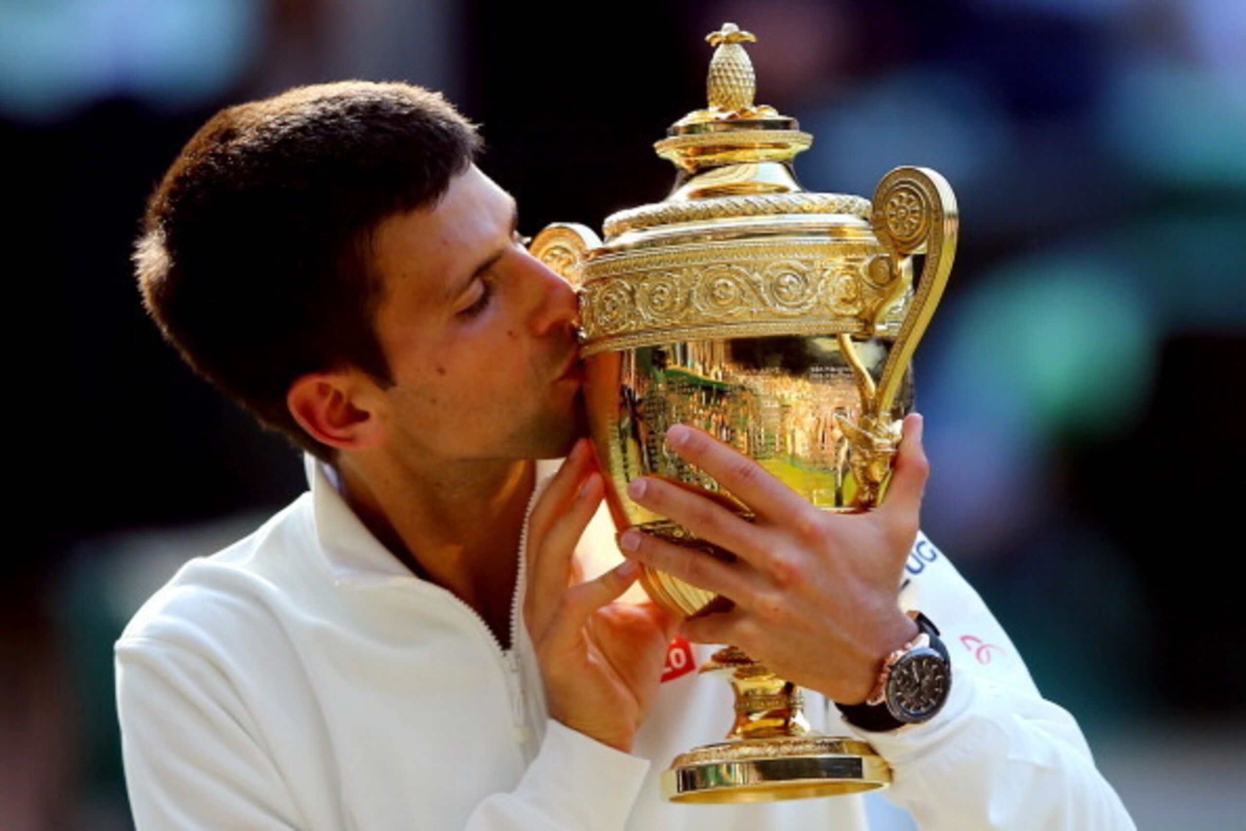 LONDON, ENGLAND - JULY 06:  Novak Djokovic of Serbia kisses the Gentlemen's Singles Trophy following his victory in the Gentlemen's Singles Final match against Roger Federer of Switzerland on day thirteen of the Wimbledon Lawn Tennis Championships at the 