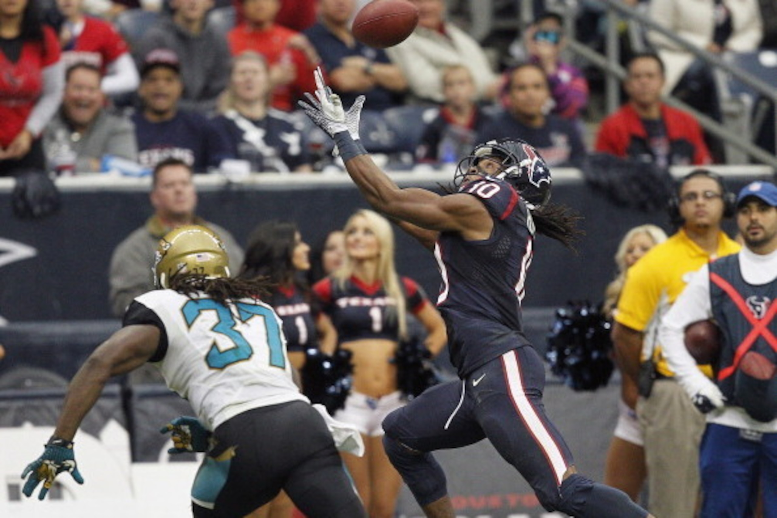 HOUSTON, TX - NOVEMBER 24:  DeAndre Hopkins #10 of the Houston Texans attempts to catch the ball as  Johnathan Cyprien #37 of the Jacksonville Jaguars defends in the fourth quarter at Reliant Stadium on November 24, 2013 in Houston, Texas.  (Photo by Bob 