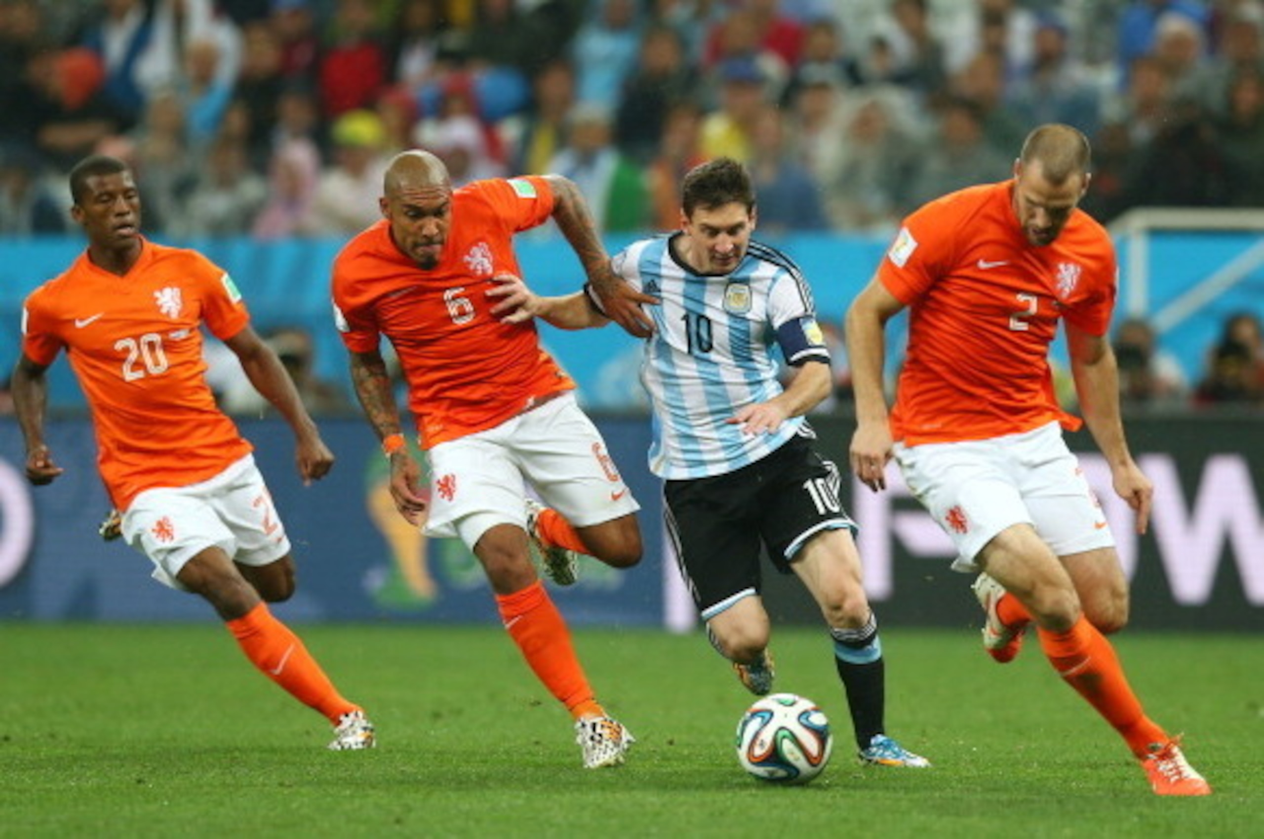 SAO PAULO, BRAZIL - JULY 09:  Lionel Messi of Argentina controls the ball as (L-R) Georginio Wijnaldum, Nigel de Jong and Ron Vlaar give chase during the 2014 FIFA World Cup Brazil Semi Final match between the Netherlands and Argentina at Arena de Sao Pau