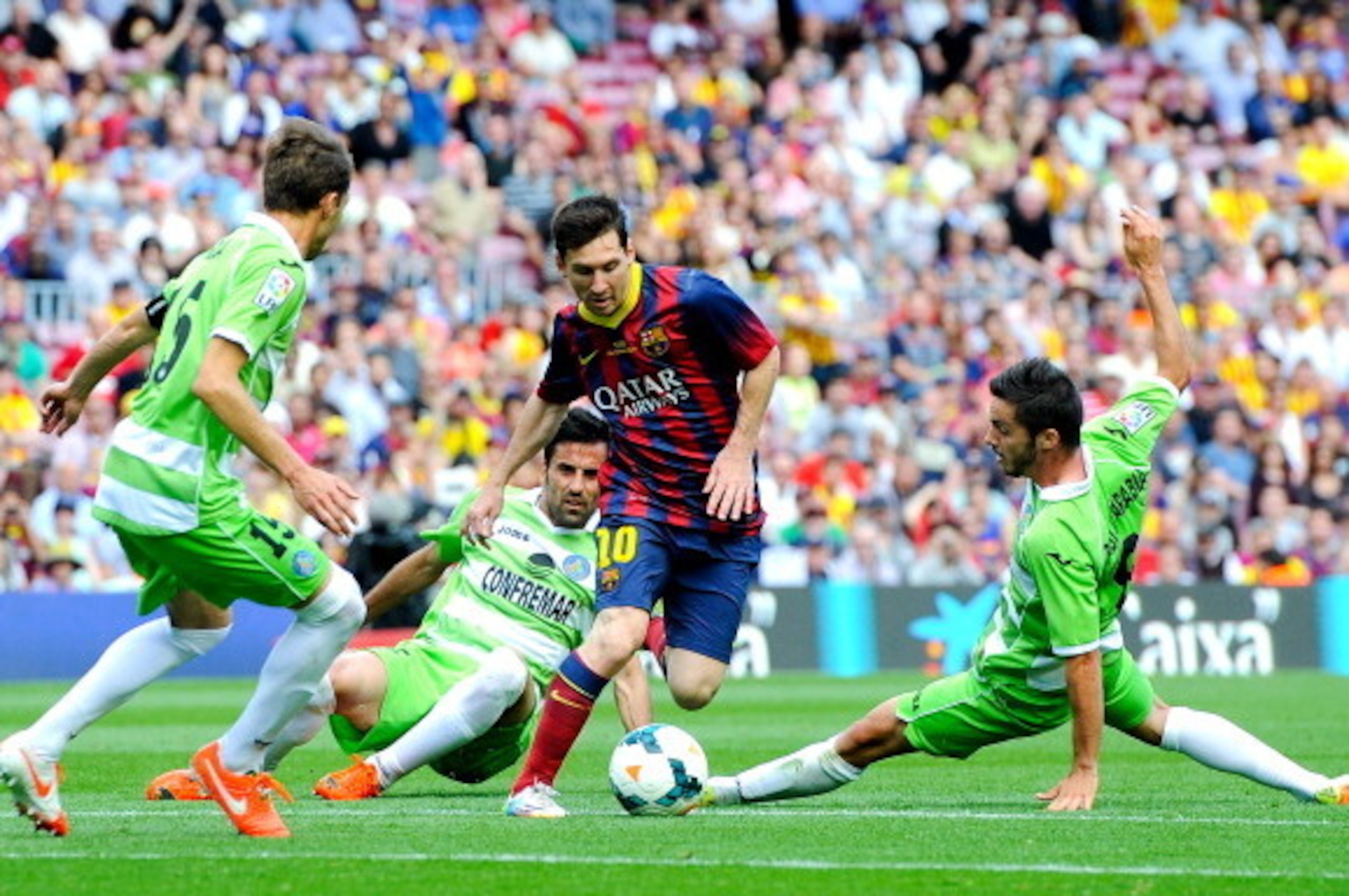 BARCELONA, SPAIN - MAY 03:  Lionel Messi of FC Barcelona competes for the ball among Getafe CF players during the La Liga match between FC Barcelona and Getafe CF at Nou Camp on May 3, 2014 in Barcelona, Spain.  (Photo by David Ramos/Getty Images)