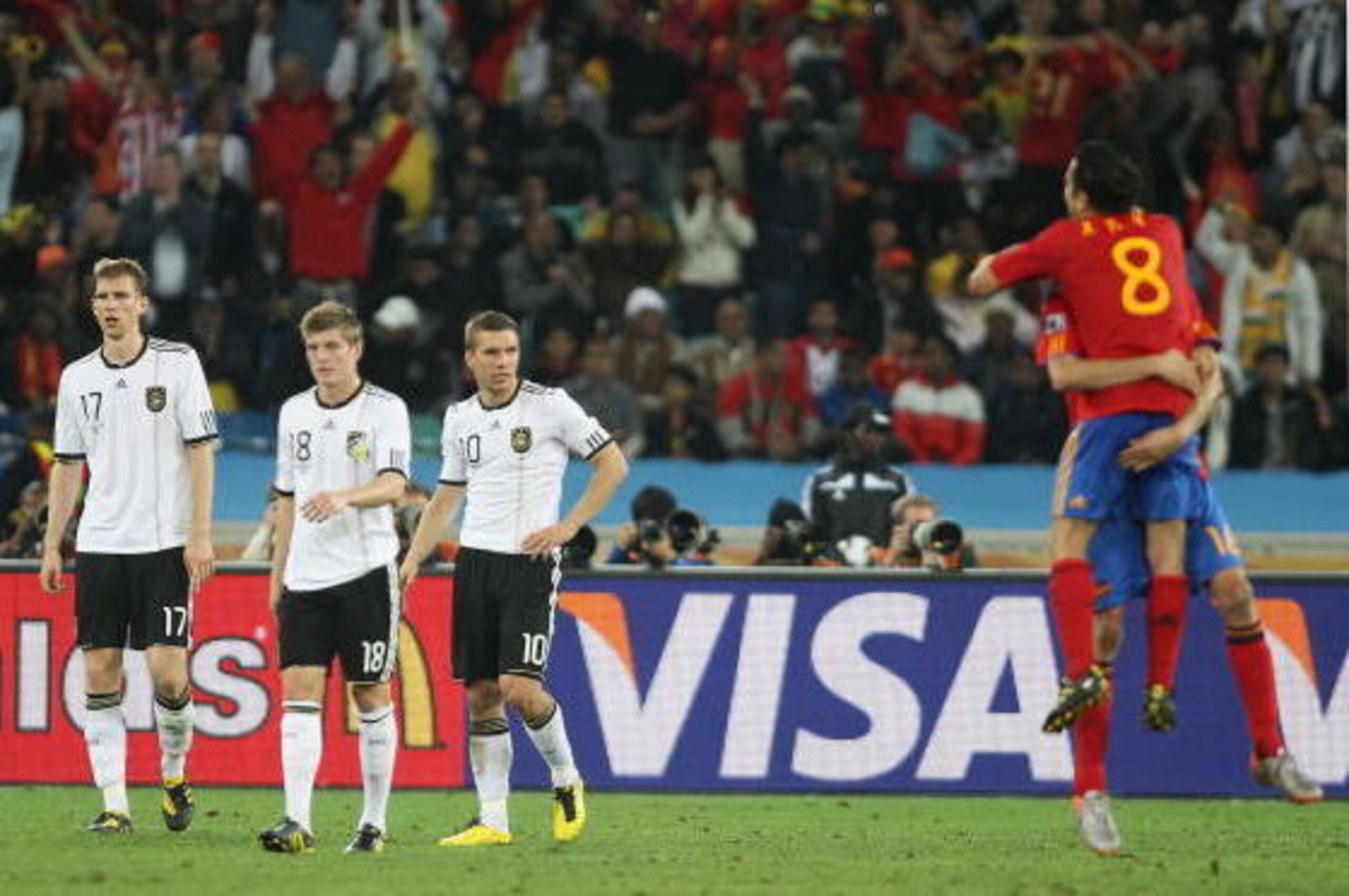 DURBAN, SOUTH AFRICA - JULY 07:  Per Mertesacker, Toni Kroos and Lukas Podolski of Germany show their dejection after being knocked out of the competition during the 2010 FIFA World Cup South Africa Semi Final match between Germany and Spain at Durban Sta