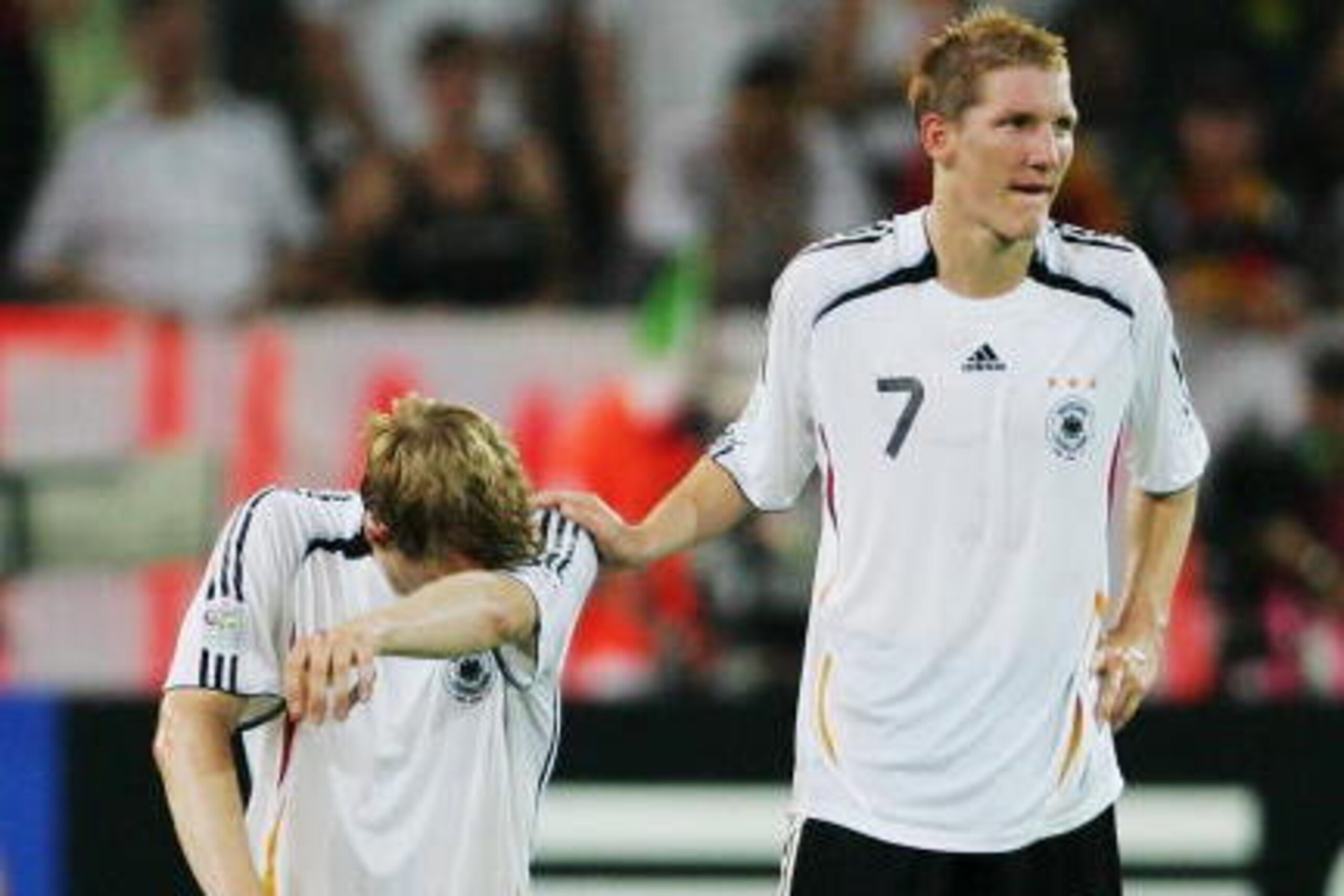 DORTMUND, GERMANY - JULY 04: Per Mertesacker (L) of Germany is consoled by team mate Bastian Schweinsteiger following their team's defeat at the end of the FIFA World Cup Germany 2006 Semi-final match between Germany and Italy played at the Stadium Dortmu