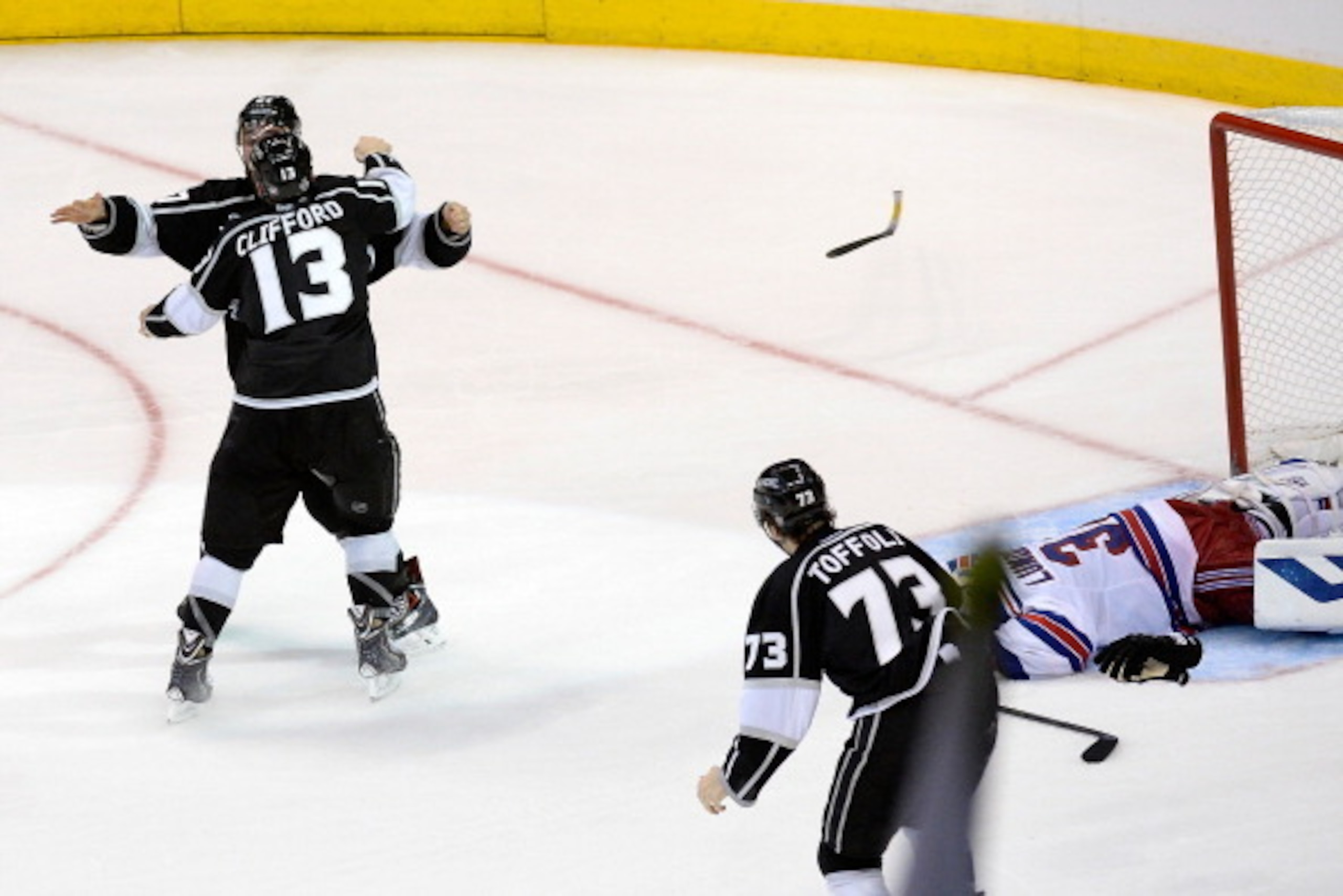 LOS ANGELES, CA - JUNE 13:  Alec Martinez #27 of the Los Angeles Kings celebrates with Kyle Clifford #13 after Martinez scores the game-winning goal in double overtime against goaltender Henrik Lundqvist #30 of the New York Rangers to give the Kings the 3