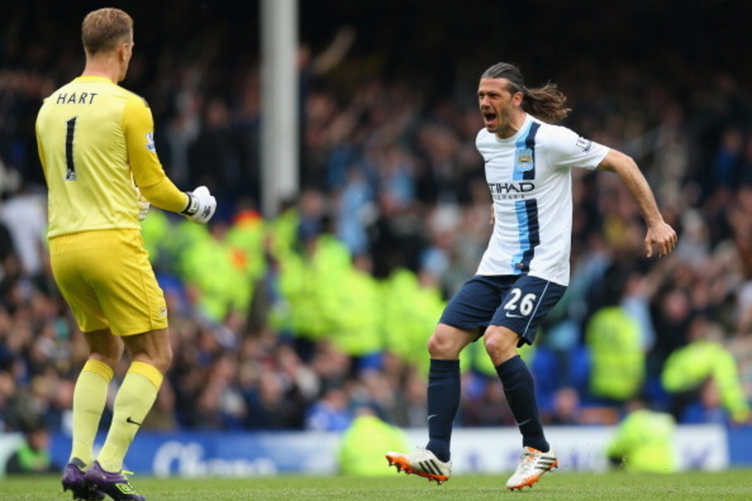 LIVERPOOL, ENGLAND - MAY 03:  Martin Demichelis of Manchester City celebrates his team's second goal with team-mate Joe Hart during the Barclays Premier League match between Everton and Manchester City at Goodison Park on May 3, 2014 in Liverpool, England