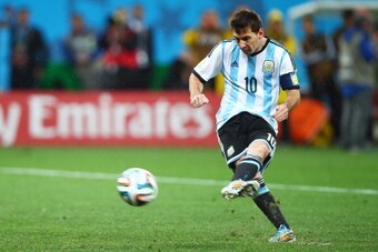 SAO PAULO, BRAZIL - JULY 09:  Lionel Messi of Argentina shoots and scores a goal in a penalty shootout during the 2014 FIFA World Cup Brazil Semi Final match between the Netherlands and Argentina at Arena de Sao Paulo on July 9, 2014 in Sao Paulo, Brazil.
