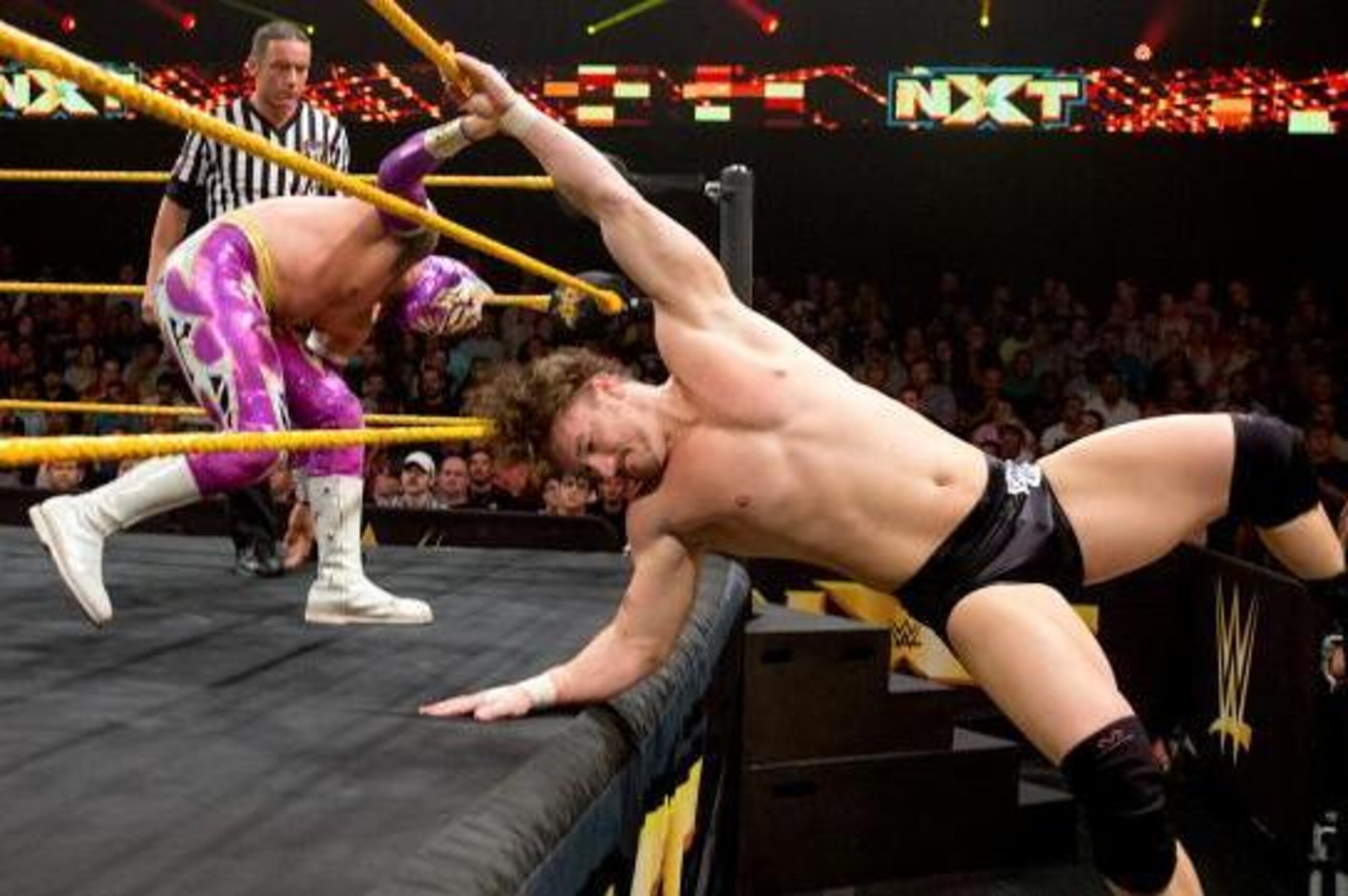 Sin Cara tosses Wesley Blake out of the ring.