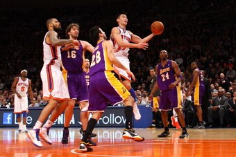NEW YORK, NY - FEBRUARY 10:  Jeremy Lin #17 of the New York Knicks drives for a shot attempt in the fourth quarter against Jason Kapono #28 and Kobe Bryant #24 of the Los Angeles Lakers at Madison Square Garden on February 10, 2012 in New York City.  NOTE