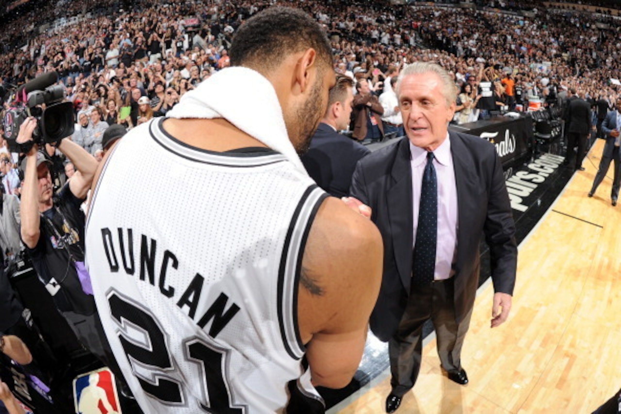 SAN ANTONIO, TX - JUNE 15: Tim Duncan #21 of the San Antonio Spurs and Pat Riley of the Miami Heat shake hands after the San Antonio Spurs victory in Game Five to win the 2014 NBA Finals between the Miami Heat and San Antonio Spurs at AT&T Center on June 