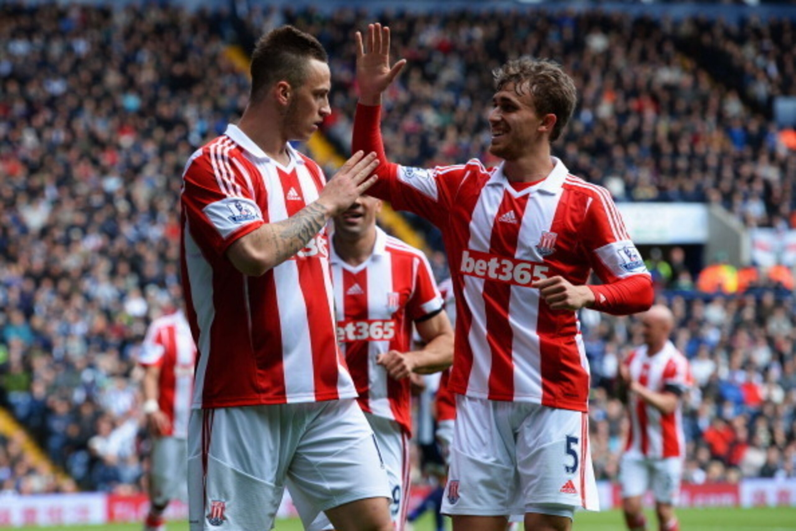 WEST BROMWICH, ENGLAND - MAY 11:  Marko Arnautovic (L) and Marc Muniesa of Stoke City  celebrate an own goal by Gareth McAuley of West Bromwich Albion (not pictured) during the Barclays Premier League match between West Bromwich Albion and Stoke City at T