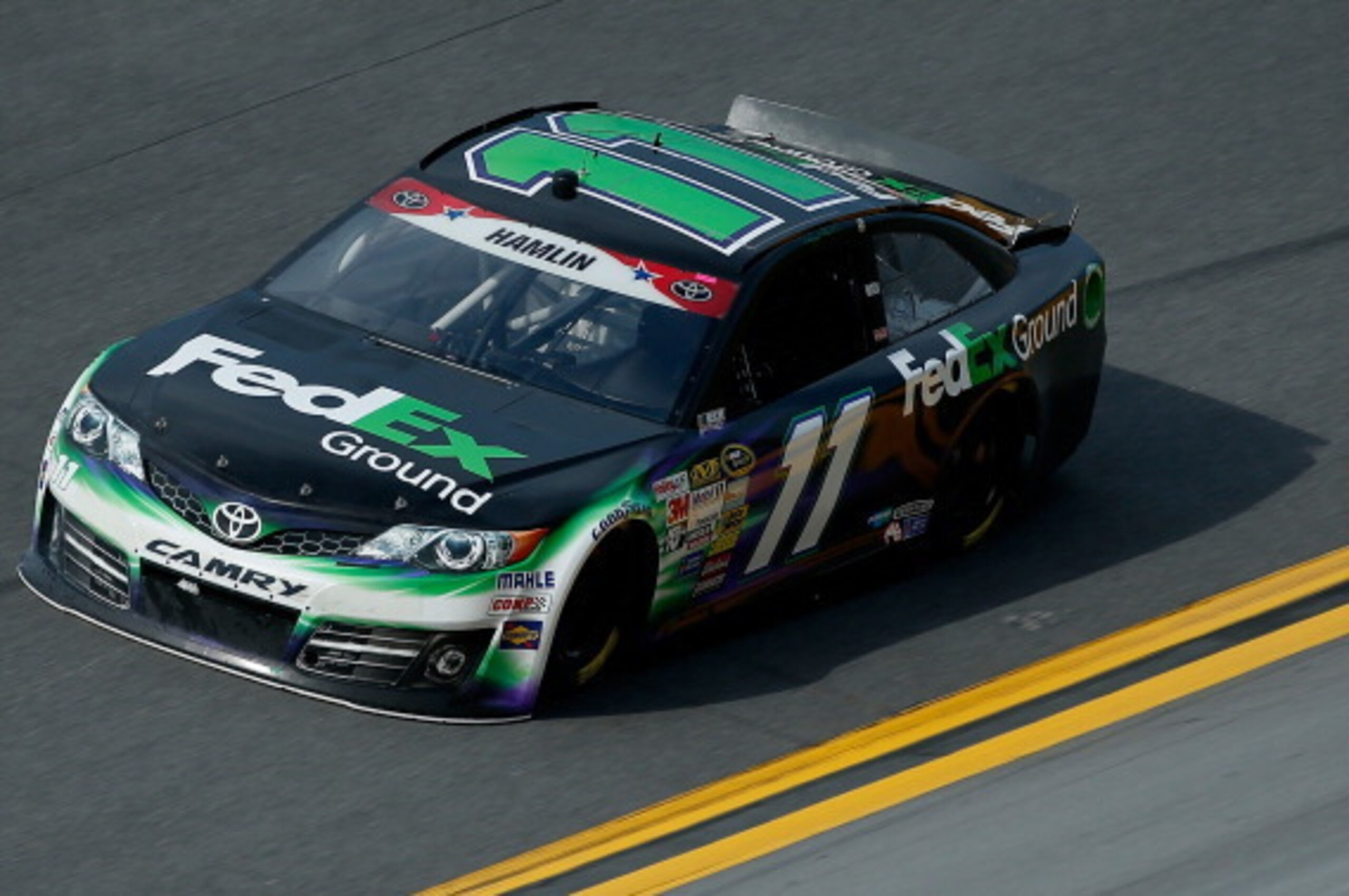 DAYTONA BEACH, FL - JULY 03: Denny Hamlin, driver of the #11 FedEx Ground Toyota, practices for the NASCAR Sprint Cup Series Coke Zero 400 at Daytona International Speedway on July 3, 2014 in Daytona Beach, Florida.  (Photo by Scott Halleran/Getty Images)