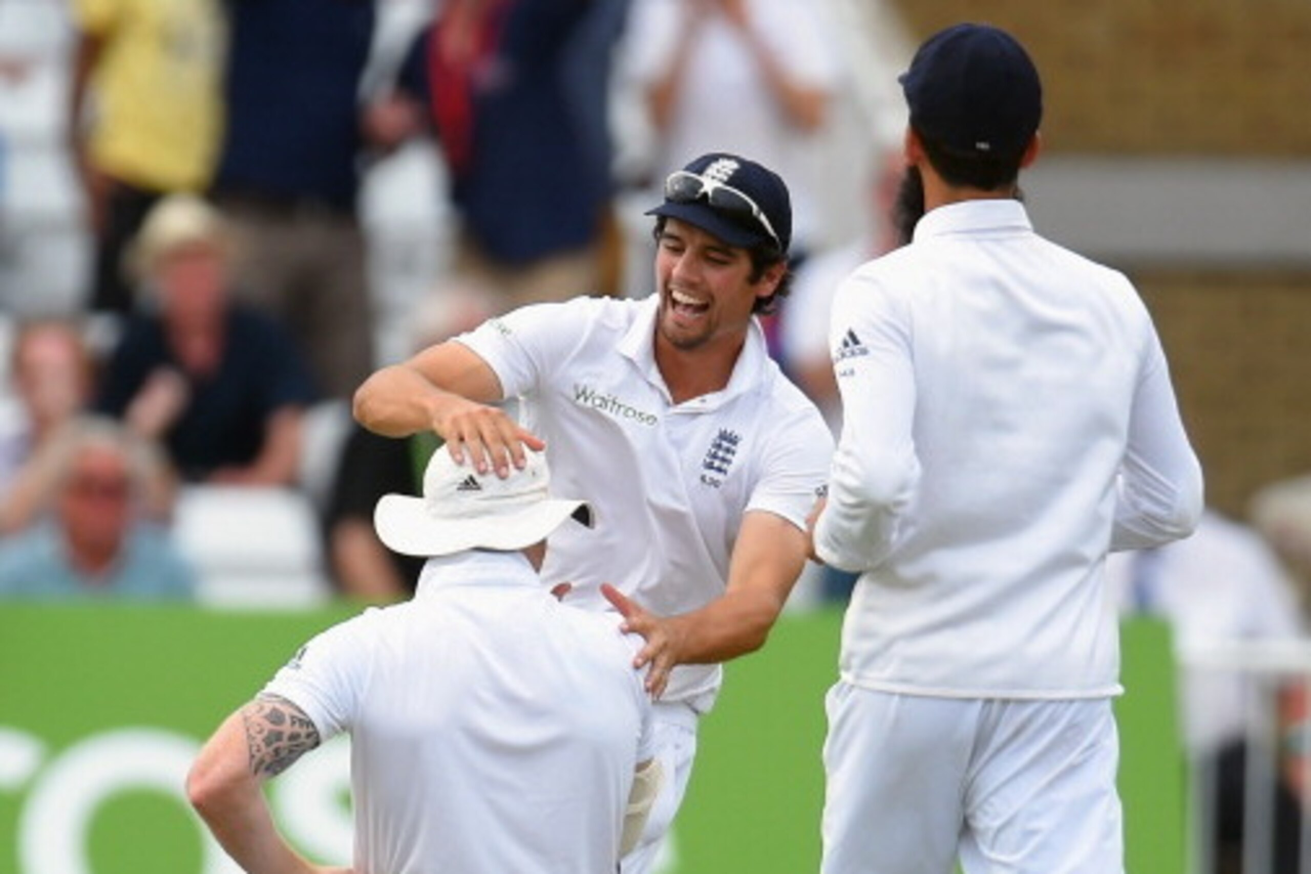 NOTTINGHAM, ENGLAND - JULY 12:  England captain Alastair Cook (c) congratulates Ben Stokes after he had caught India batsman Cheteshwar Pujara during day four of the 1st  Investec Test Match between England and India at  Trent Bridge on July 12, 2014 in N
