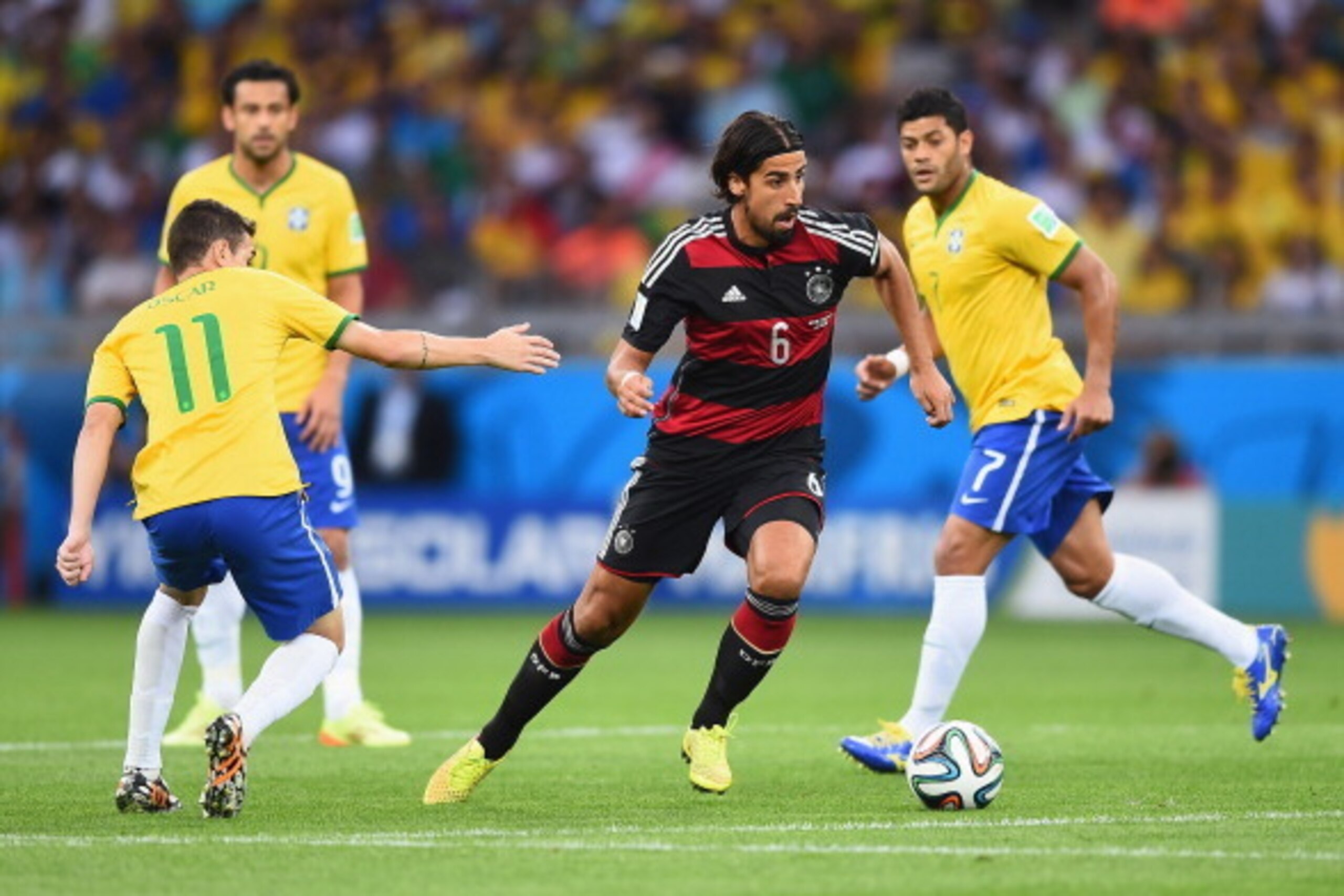 BELO HORIZONTE, BRAZIL - JULY 08: Sami Khedira (C) of Germany runs past Oscar of Brazil with the ball during the 2014 FIFA World Cup Brazil Semi Final match between Brazil and Germany at Estadio Mineirao on July 8, 2014 in Belo Horizonte, Brazil.  (Photo 