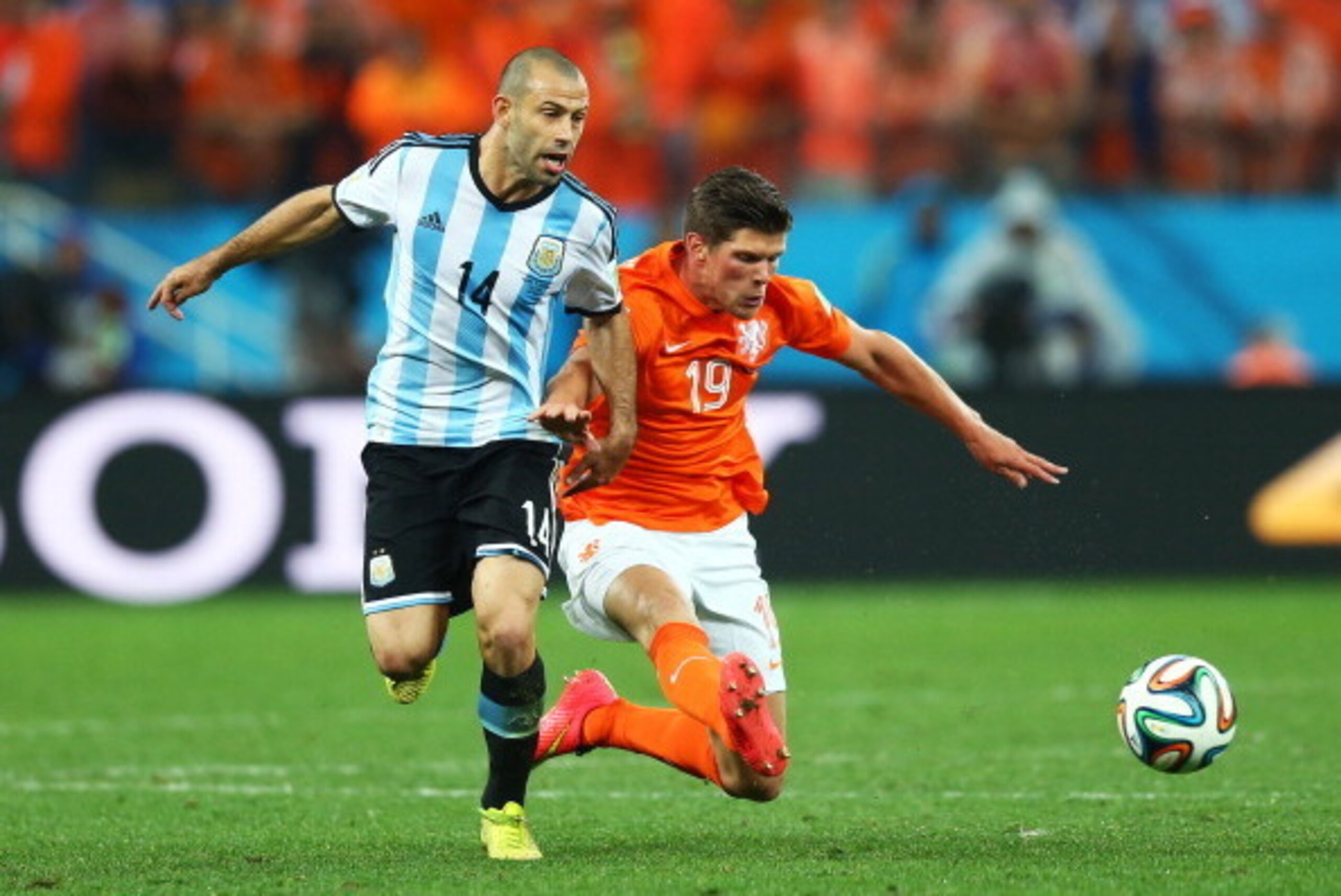 SAO PAULO, BRAZIL - JULY 09: Klaas-Jan Huntelaar of the Netherlands challenges Javier Mascherano of Argentina during the 2014 FIFA World Cup Brazil Semi Final match between the Netherlands and Argentina at Arena de Sao Paulo on July 9, 2014 in Sao Paulo, 