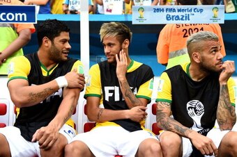 BRASILIA, BRAZIL - JULY 12:  (L-R) Hulk, Neymar and Dani Alves of Brazil look on from the bench during the 2014 FIFA World Cup Brazil Third Place Playoff match between Brazil and the Netherlands at Estadio Nacional on July 12, 2014 in Brasilia, Brazil.  (