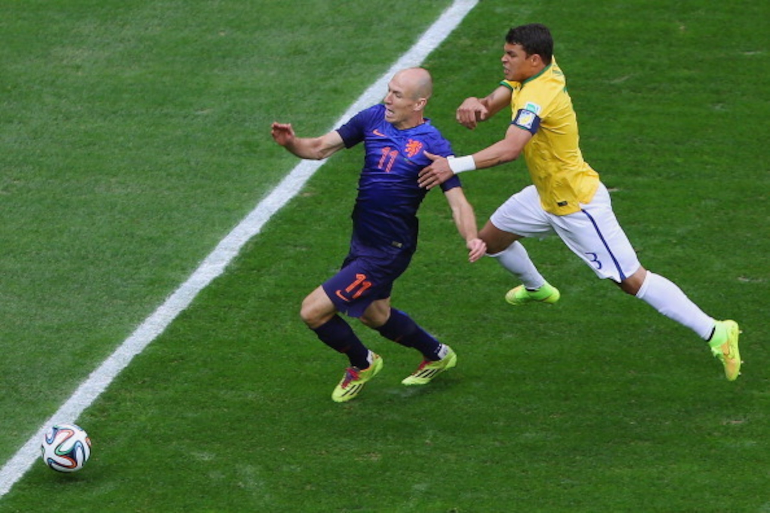 BRASILIA, BRAZIL - JULY 12:  Thiago Silva of Brazil challenges Arjen Robben of the Netherlands resulting in a penalty kick for the Netherlands and yellow card for Silva during the 2014 FIFA World Cup Brazil Third Place Playoff match between Brazil and the