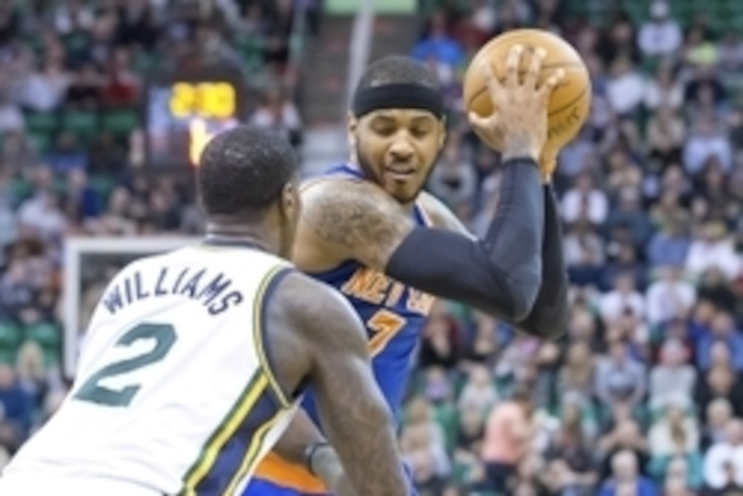Mar 31, 2014; Salt Lake City, UT, USA; Utah Jazz forward Marvin Williams (2) defends against New York Knicks forward Carmelo Anthony (7) during the first half at EnergySolutions Arena. Mandatory Credit: Russ Isabella-USA TODAY Sports