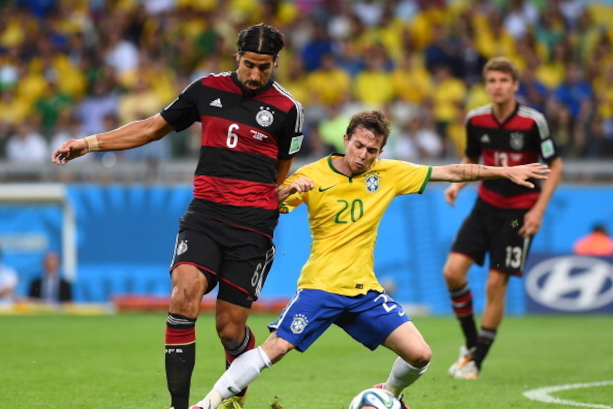 BELO HORIZONTE, BRAZIL - JULY 08:  Bernard of Brazil is challenged by Sami Khedira of Germany during the 2014 FIFA World Cup Brazil Semi Final match between Brazil and Germany at Estadio Mineirao on July 8, 2014 in Belo Horizonte, Brazil.  (Photo by Laure