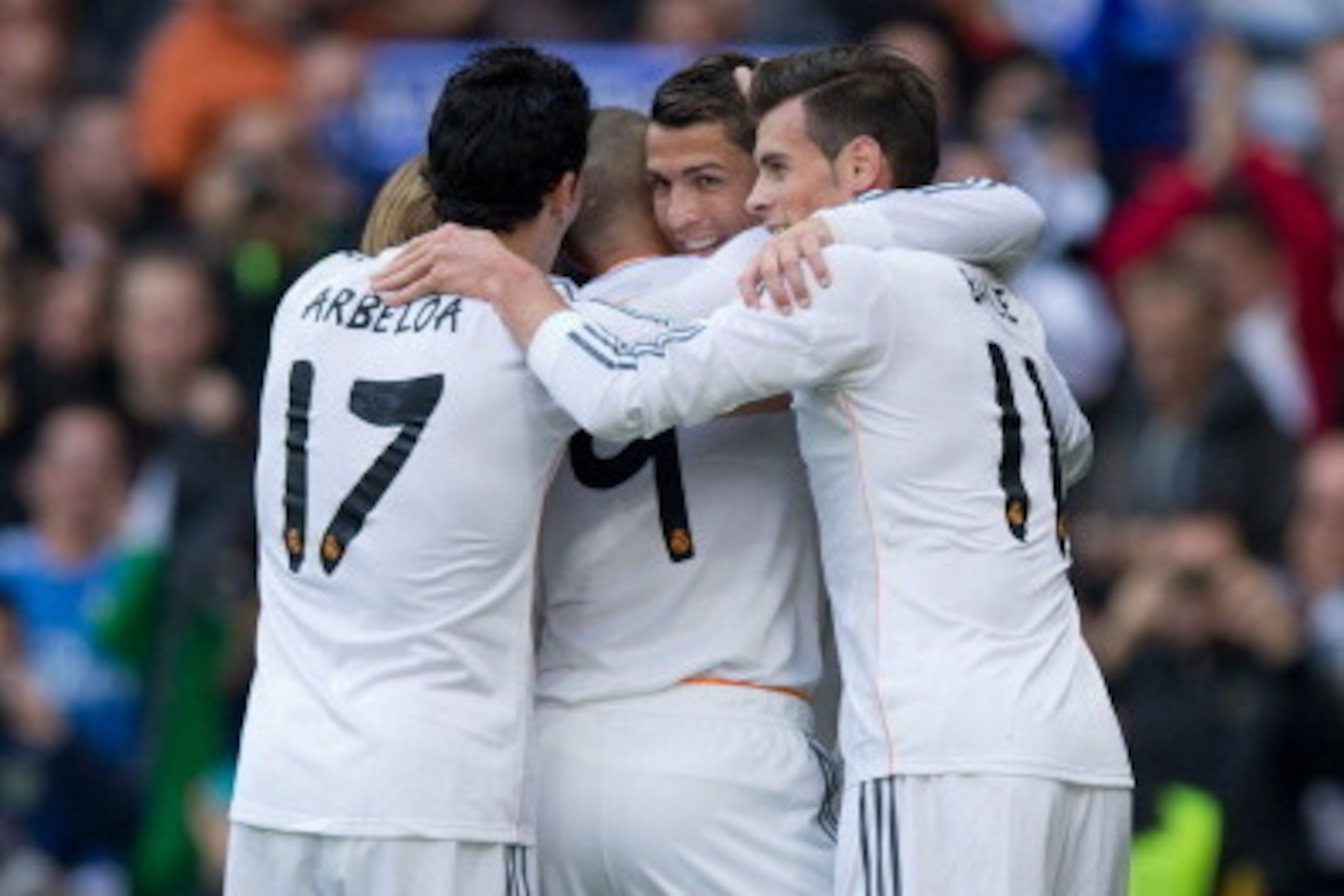 MADRID, SPAIN - NOVEMBER 09:  Karim Benzema (2ndL) celebrates scoring their second goal with teammates Cristiano Ronaldo (2ndR), Gareth Bale (R) and Alvaro Arbeloa (L) during the La Liga match between Real Madrid CF and Real Sociedad de Futbol  at Estadio