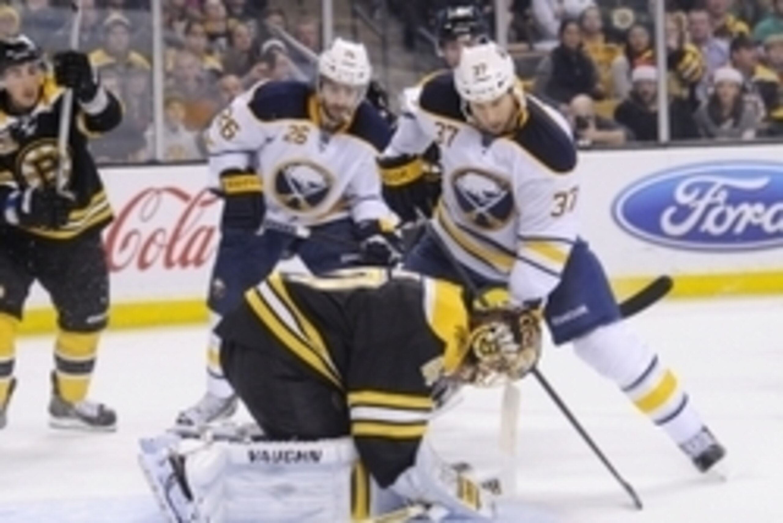 Dec 21, 2013; Boston, MA, USA; Boston Bruins goalie Tuukka Rask (40) ties up the puck in front of Buffalo Sabres left wing Matt Ellis (37) and left wing Matt Moulson (26) during the second period at TD Banknorth Garden. Mandatory Credit: Bob DeChiara-USA 