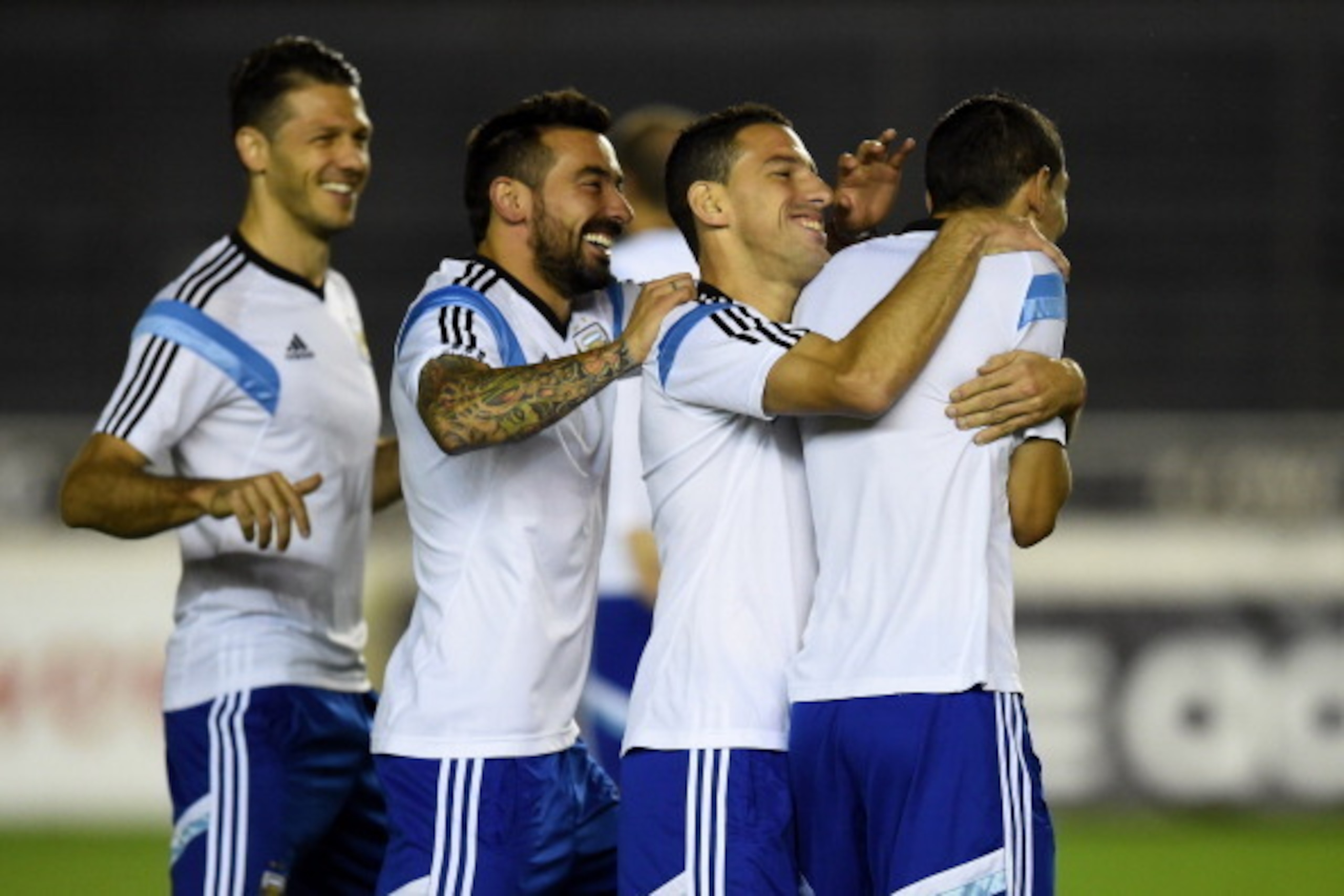RIO DE JANEIRO, BRAZIL - JULY 12:  (L-R) Argentina teammates Martin Demichelis, Gonzalo Higuain and  Maxi Rodriguez share a joke with Angel di Maria during the Argentina training session, ahead of the 2014 FIFA World Cup Final, at Estadio Sao Januario on 