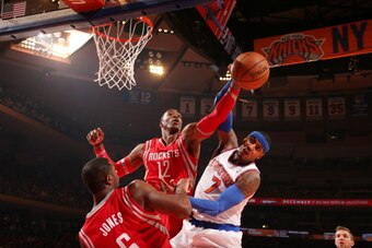 NEW YORK, NY - NOVEMBER 14: Dwight Howard #12 of the Houston Rockets blocks a shot against Carmelo Anthony #7 of the New York Knicks during a game at Madison Square Garden in New York City on November 14, 2013.  NOTE TO USER: User expressly acknowledges a