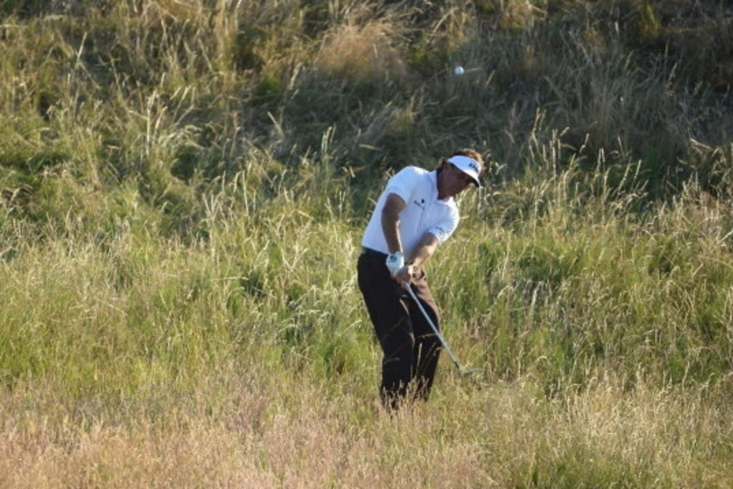 GULLANE, SCOTLAND - JULY 19:  Phil Mickelson of the United States hits out of the rough during the second round of the 142nd Open Championship at Muirfield on July 19, 2013 in Gullane, Scotland.  (Photo by Stuart Franklin/Getty Images)