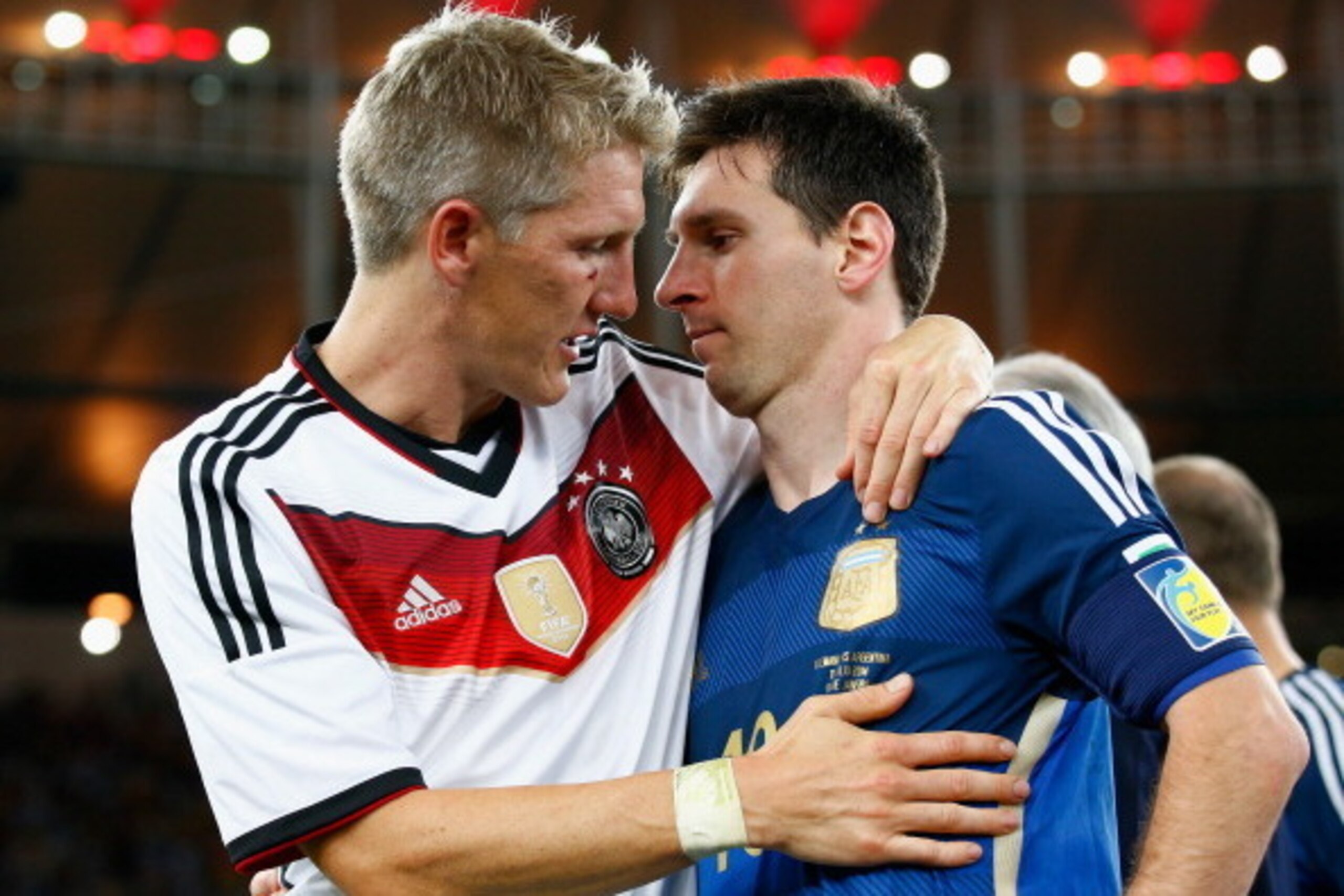 RIO DE JANEIRO, BRAZIL - JULY 13:  Bastian Schweinsteiger of Germany hugs Lionel Messi of Argentina after Germany's 1-0 victory  in extra time during the 2014 FIFA World Cup Brazil Final match between Germany and Argentina at Maracana on July 13, 2014 in 