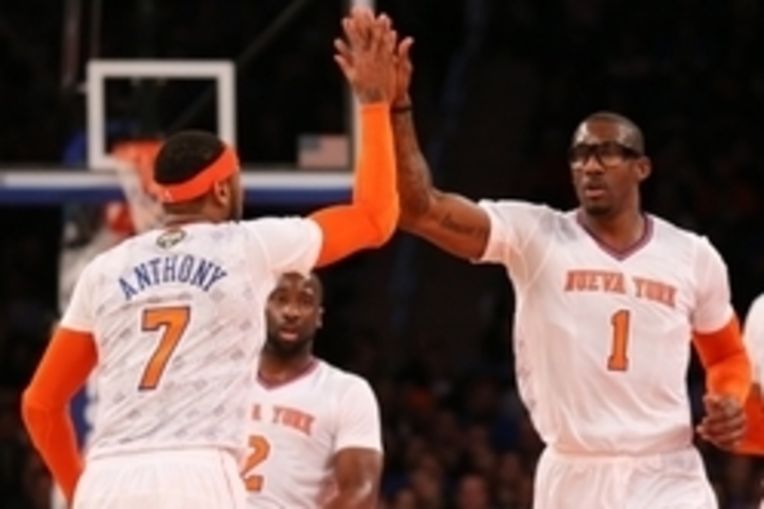 Mar 23, 2014; New York, NY, USA;  New York Knicks forward Carmelo Anthony (7) celebrates with forward Amar'e Stoudemire (1) after scoring during the first quarter against the Cleveland Cavaliers at Madison Square Garden. Mandatory Credit: Anthony Gruppuso