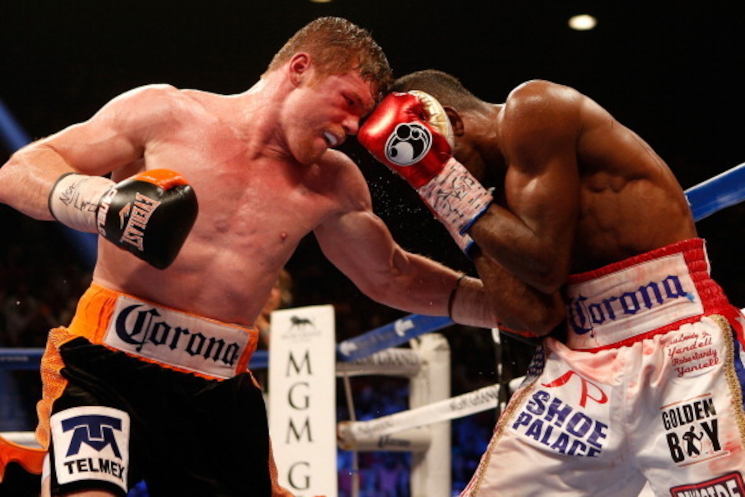 LAS VEGAS, NV - JULY 12:  (L-R) Canelo Alvarez digs a left to the body of Erislandy Lara during their junior middleweight bout at the MGM Grand Garden Arena on July 12, 2014 in Las Vegas, Nevada.  Alvarez defeated Lara by split decision. (Photo by Josh He