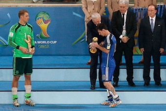 RIO DE JANEIRO, BRAZIL - JULY 13: Golden Glove winner Manuel Neuer of Germany looks on as Jose Maria Marin, President of the CBF, presents Lionel Messi of Argentina with the Golden Ball trophy during the 2014 FIFA World Cup Brazil Final match between Germ