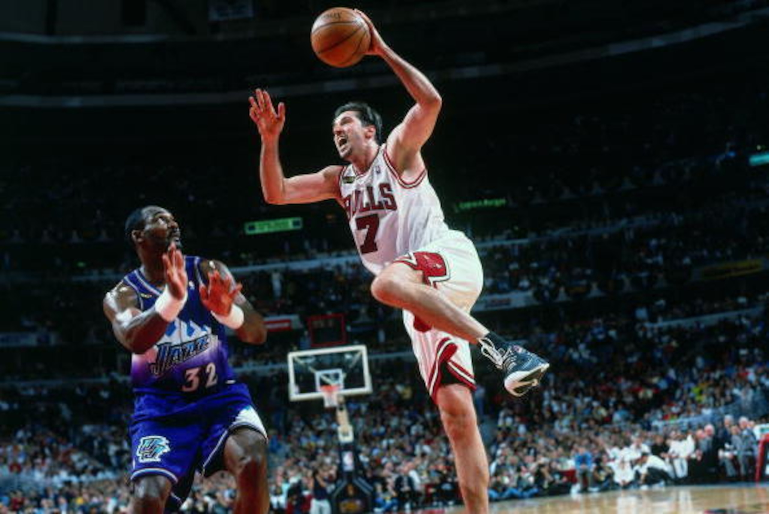 CHICAGO - JUNE 12:  Toni Kukoc #7 of the Chicago Bulls goes up for a shot against Karl Malone #32 of the Utah Jazz during Game Five of the 1998 NBA Finals played on June 12, 1998 at the United Center in Chicago, Illinois.  Utah defeated Chicago 83-81 but 