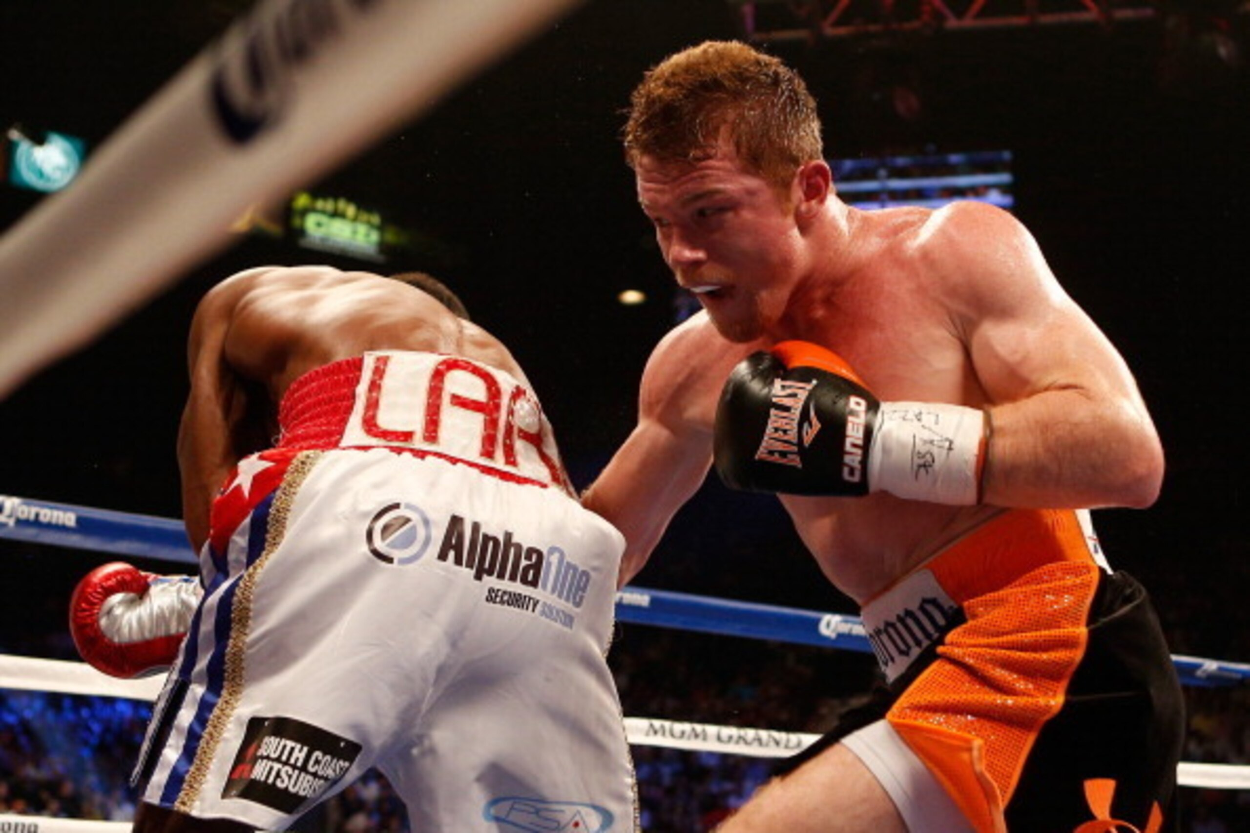 LAS VEGAS, NV - JULY 12:  (R-L) Canelo Alvarez digs a right to the body of Erislandy Lara during their junior middleweight bout at the MGM Grand Garden Arena on July 12, 2014 in Las Vegas, Nevada.  Alvarez defeated Lara by split decision.  (Photo by Josh