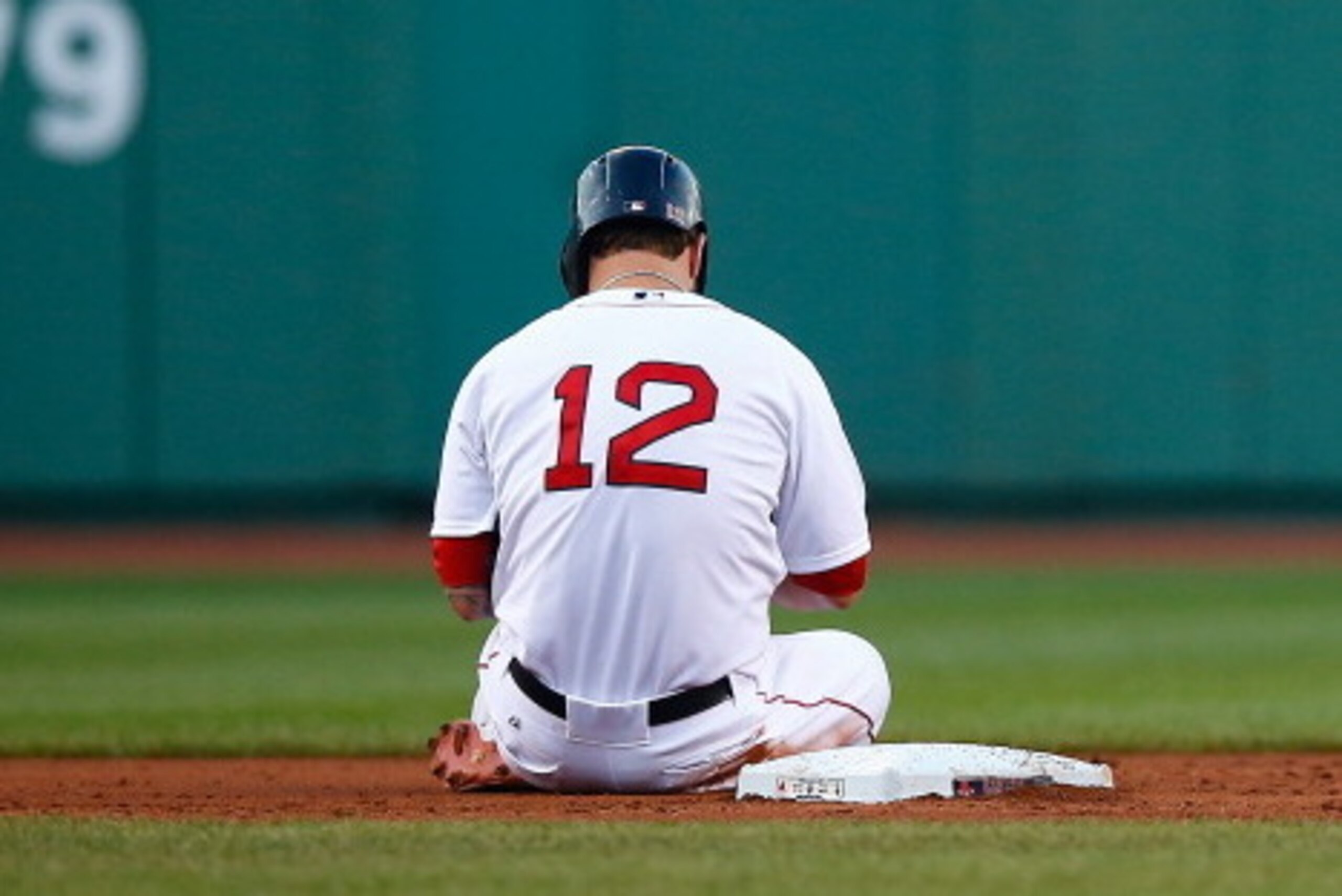 BOSTON, MA - JULY 08: Mike Napoli #12 of the Boston Red Sox sits at second base after sliding into an inning-ending double play in the first inning against the Chicago White Sox during the game at Fenway Park on July 8, 2014 in Boston, Massachusetts.  (Ph