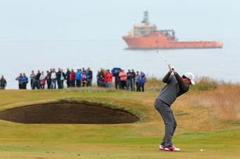 ABERDEEN, SCOTLAND - JULY 13:  Rory Mcilroy of Northern Ireland hits his approach on the first hole during the final round of the 2014 Aberdeen Asset Management Scottish Open at Royal Aberdeen Golf Club on July 13, 2014 in Aberdeen, Scotland.  (Photo by M